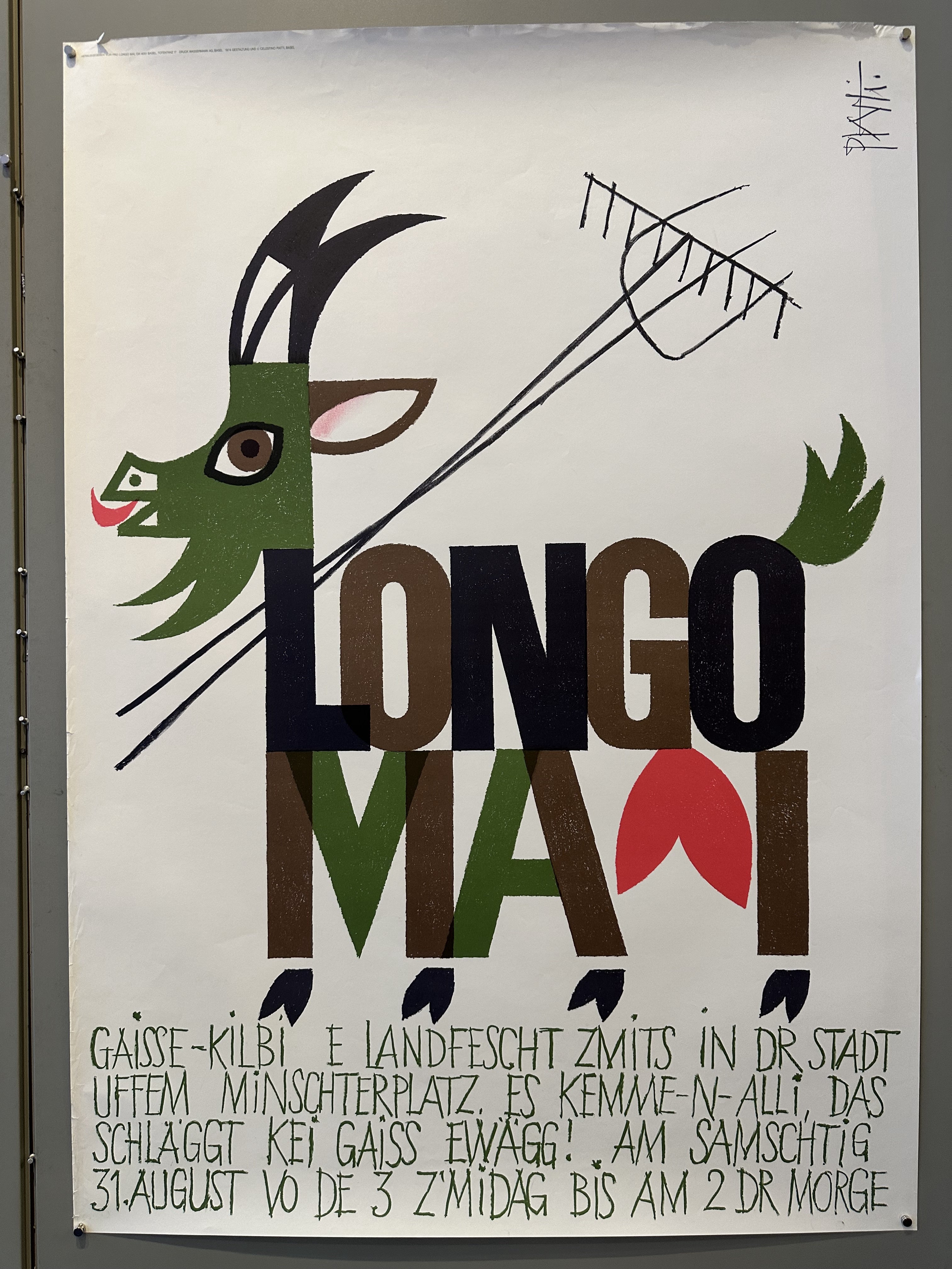 A poster featuring a stylized goat with the words "Longo Maï" prominently displayed, advertising an event called "Gaisse Kilbi" with a date and time in a Swiss German dialect.