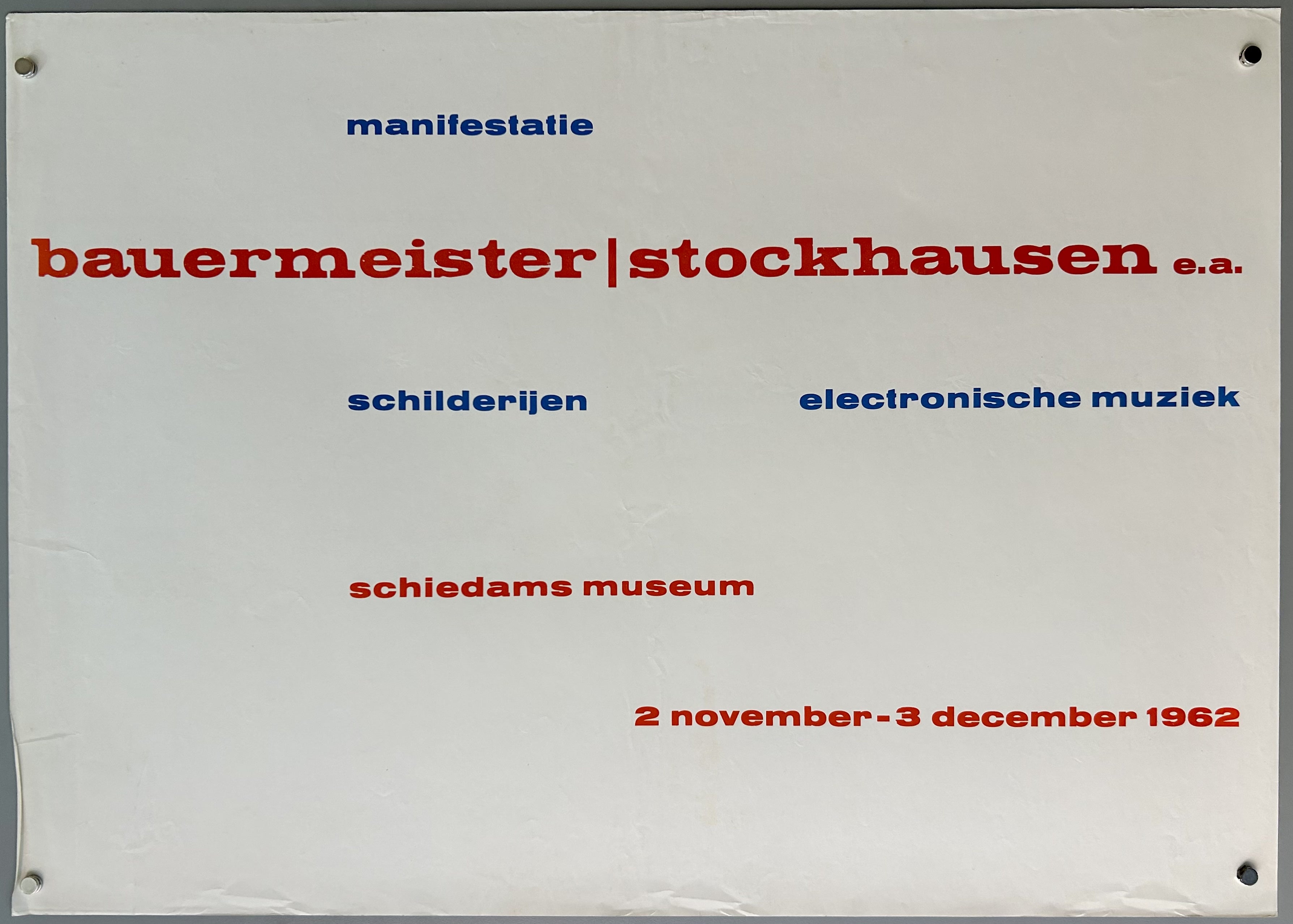 White poster with blue and red text written randomly in straight lines across.