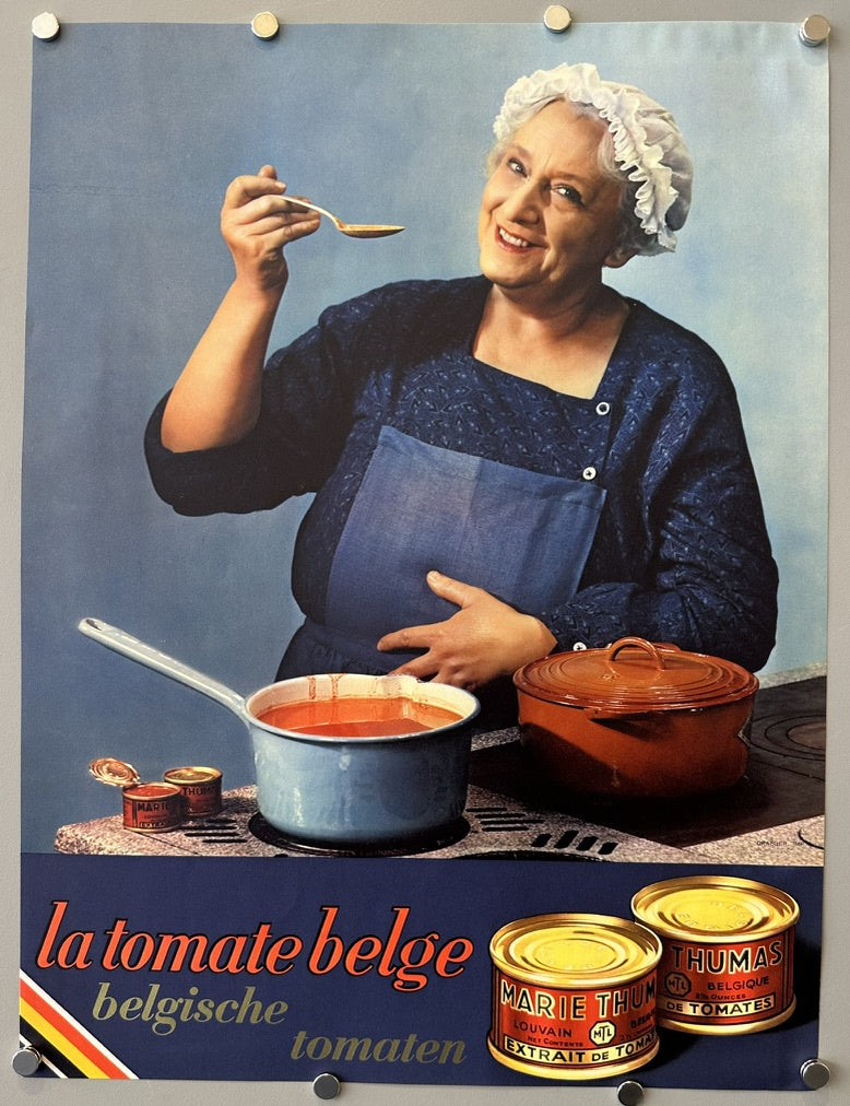 Depicts an older woman in a kitchen setting, wearing a chef's hat and apron, tasting a spoonful of tomato-based dish from a pot on a stove. Several cans of "Marie Thum" and "Thumas" tomato extract are visible in the foreground.