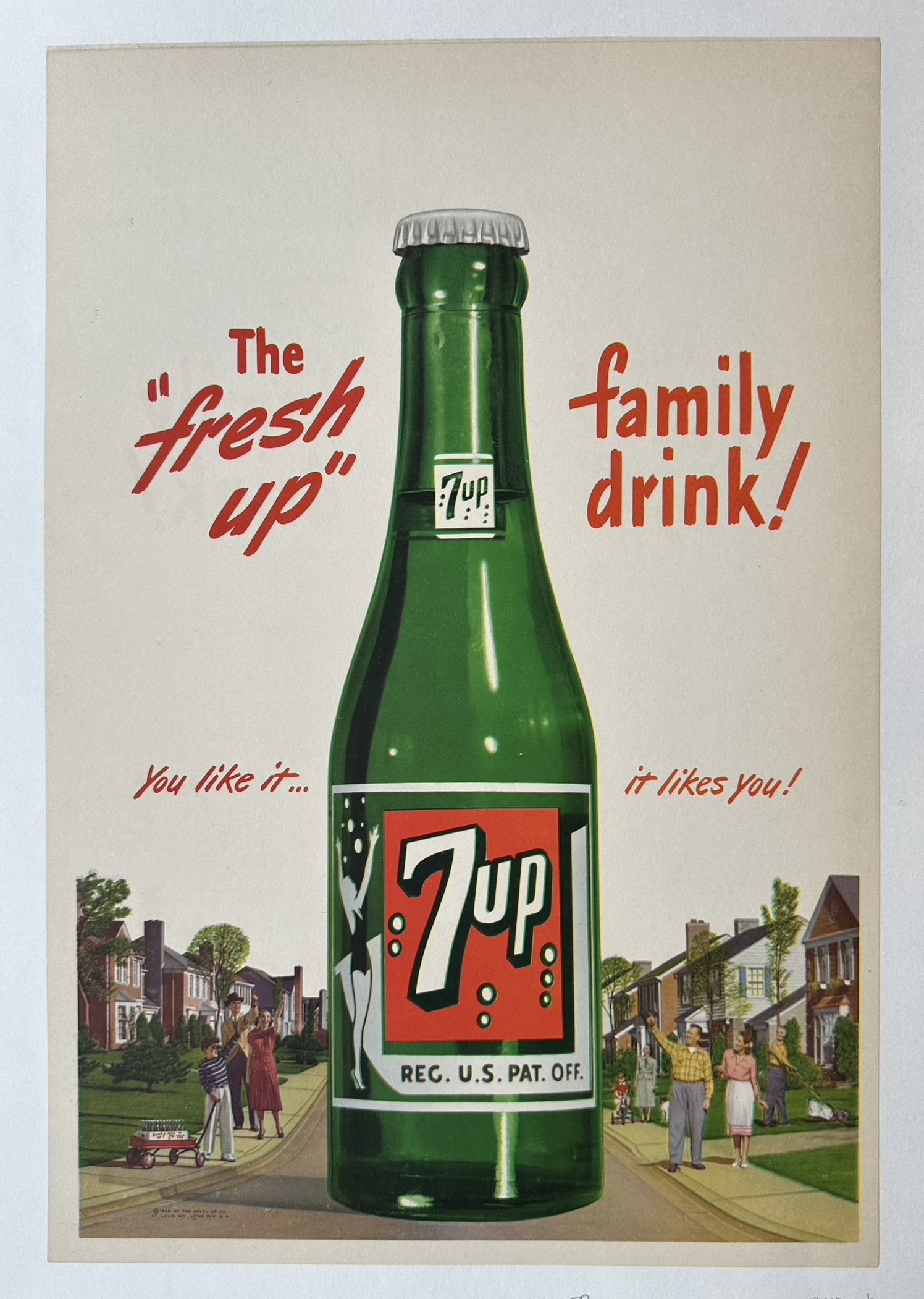 Vintage 7 Up advertisement featuring a large bottle and text promoting it as "The fresh up family drink!" with a suburban street scene.