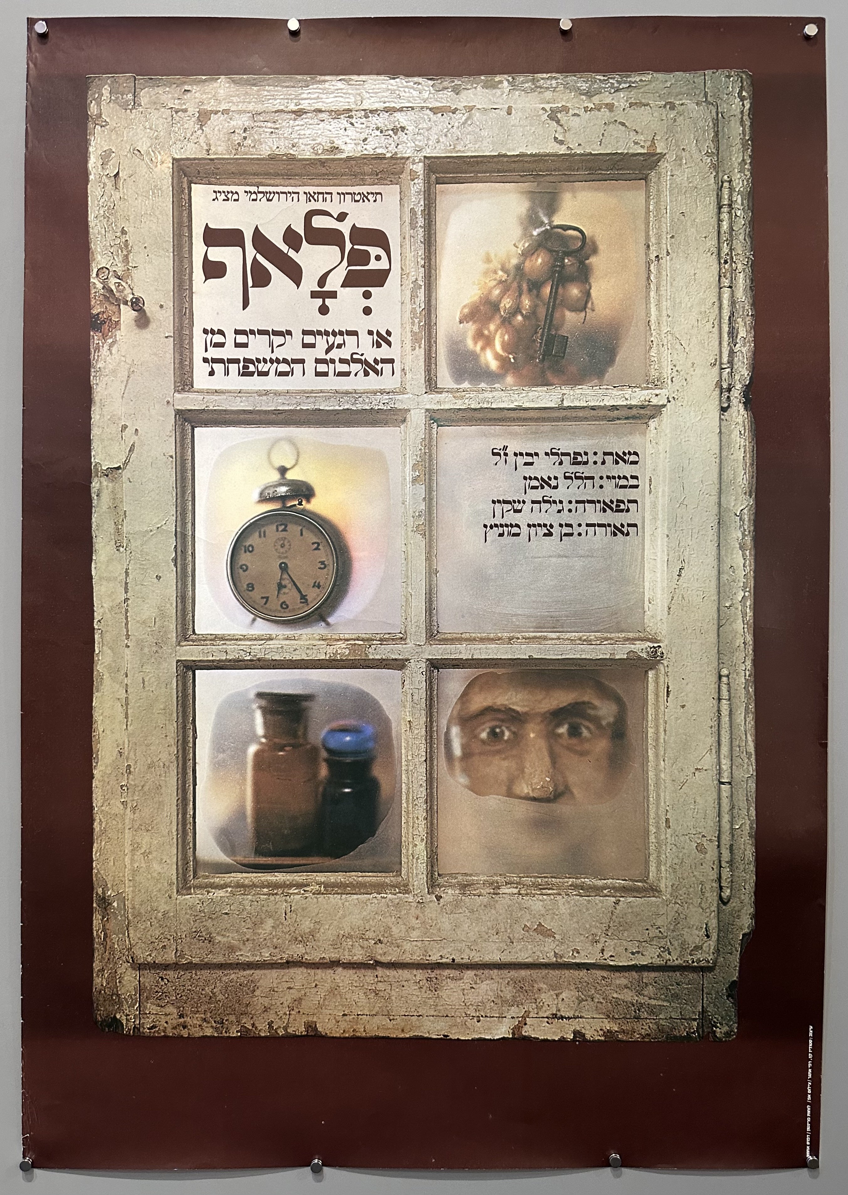 Poster promoting a play at the Khan Theater featuring a window with a man's face, an alarm clock, garlic, and bottles in the glass panes.