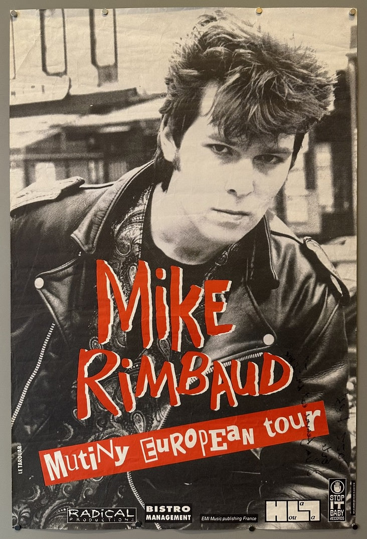 Red text overlays his image, reading "Mike RIMBAUD" in large, distressed letters, and "Mutiny European tour" below it. Smaller text at the bottom includes "RADICAL PRODUCTION", "BISTRO MANAGEMENT", "EMI Music publishing France", "STOP IT BABY records", and "LE TAROUAR" vertically on the left side.