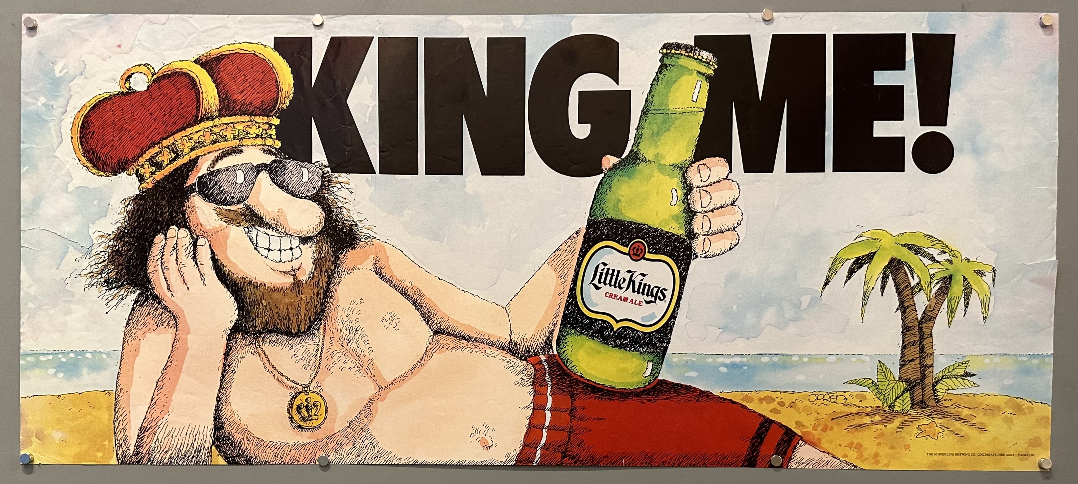 Illustration of a man dressed as a king lounges on the beach with Little Kings Cream Ale propped on his hip.