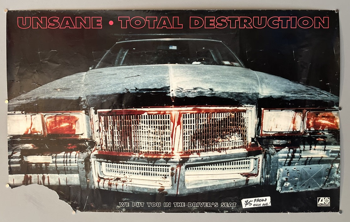 A promotional poster for Unsane's album "Total Destruction," featuring a dark, blood-splattered car with prominent text "UNSANE • TOTAL DESTRUCTION" at the top and "WE PUT YOU IN THE DRIVER'S SEAT" at the bottom