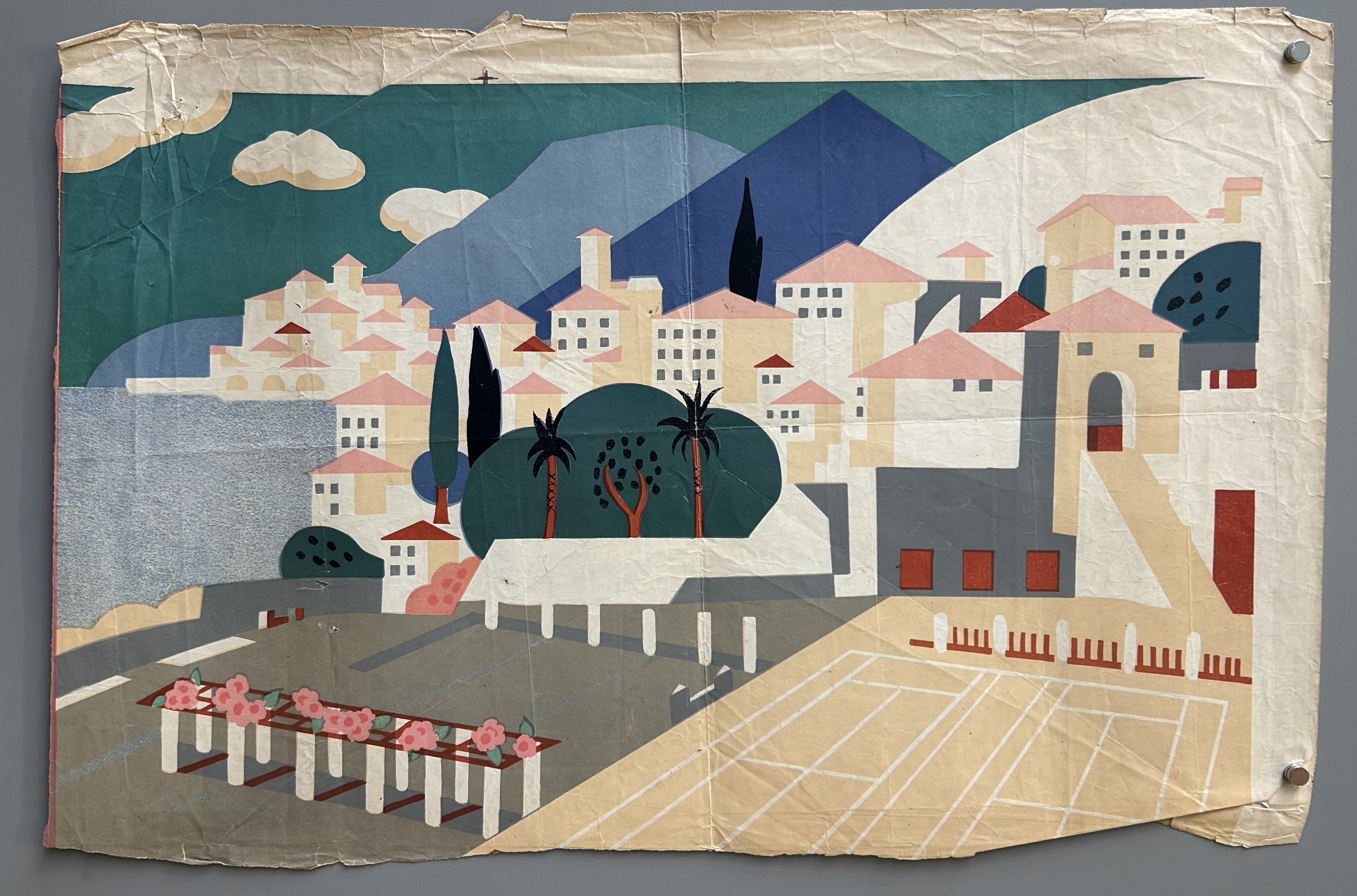 depicting a Mediterranean coastal town. The scene features a hillside village with buildings, a tennis court in the foreground, and mountains in the background.