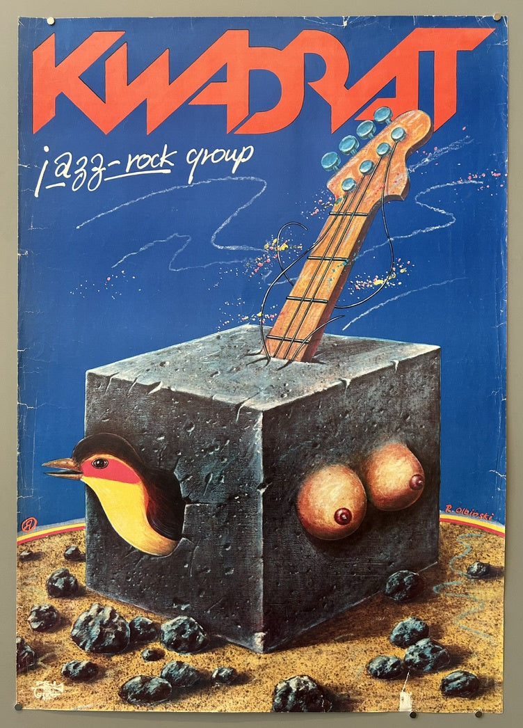 A surreal poster for the "KWADRAT jazz-rock group" featuring a stone cube with a bird's head emerging from one side and two breasts on another, a guitar neck sticking out of the top, all on a rocky, barren landscape under a blue sky. The artist's signature "R. Olbinski" is visible.