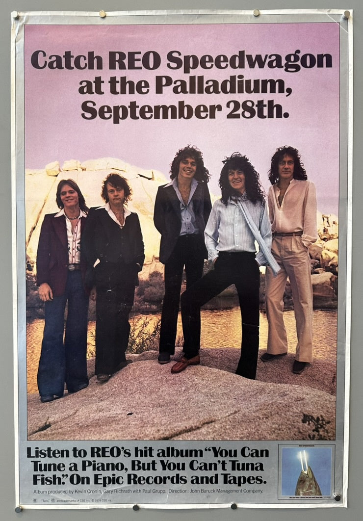 Poster featuring the band REO Speedwagon. The top of the poster reads "Catch REO Speedwagon at the Palladium, September 28th." Below this, five band members are shown standing on a rocky, desert-like landscape. At the bottom, text states: "Listen to REO's hit album 'You Can Tune a Piano, But You Can't Tuna Fish.' On Epic Records and Tapes."
