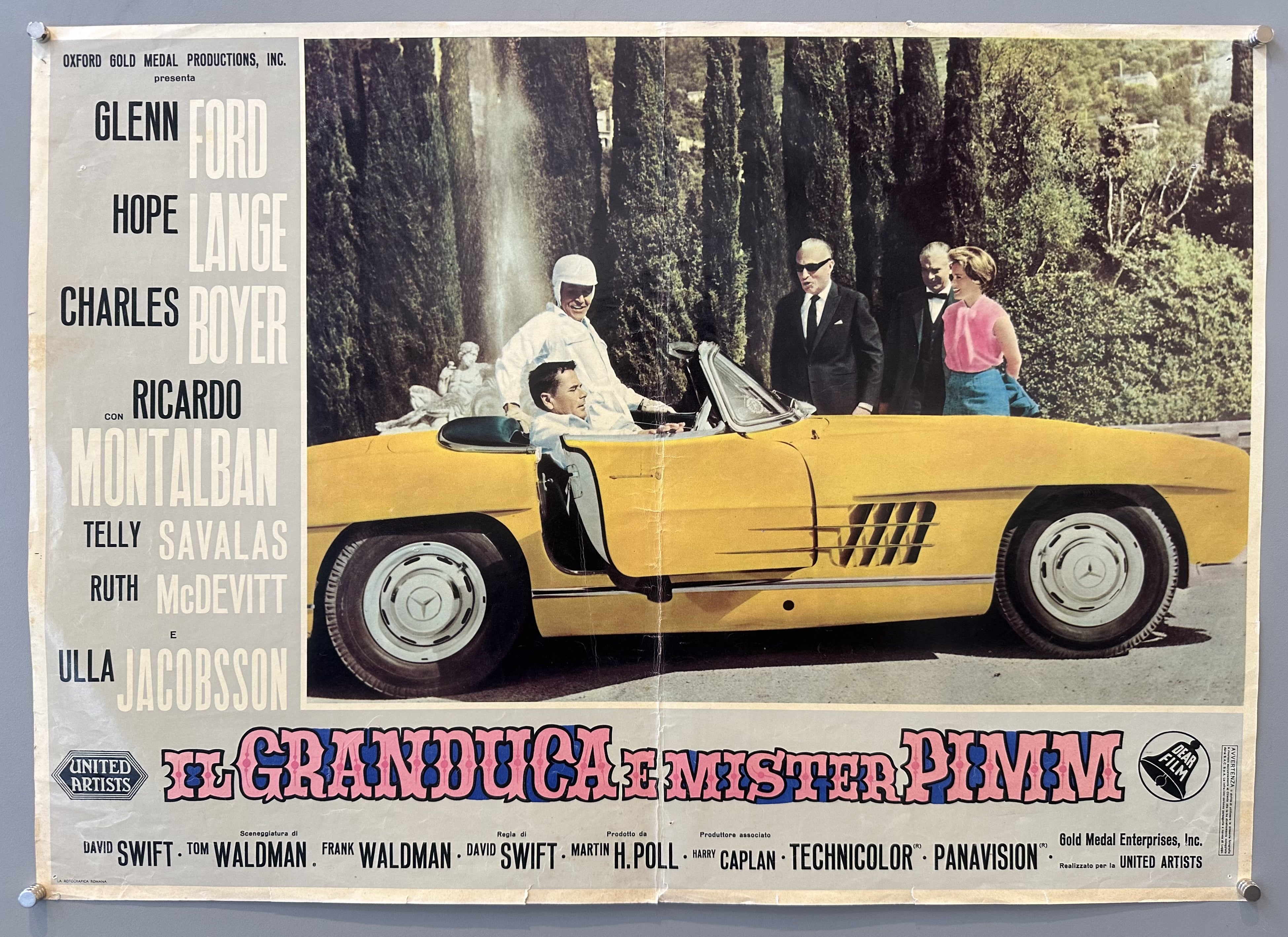 White border with grey text box and photo of a driver in a yellow convertible to the right side of it