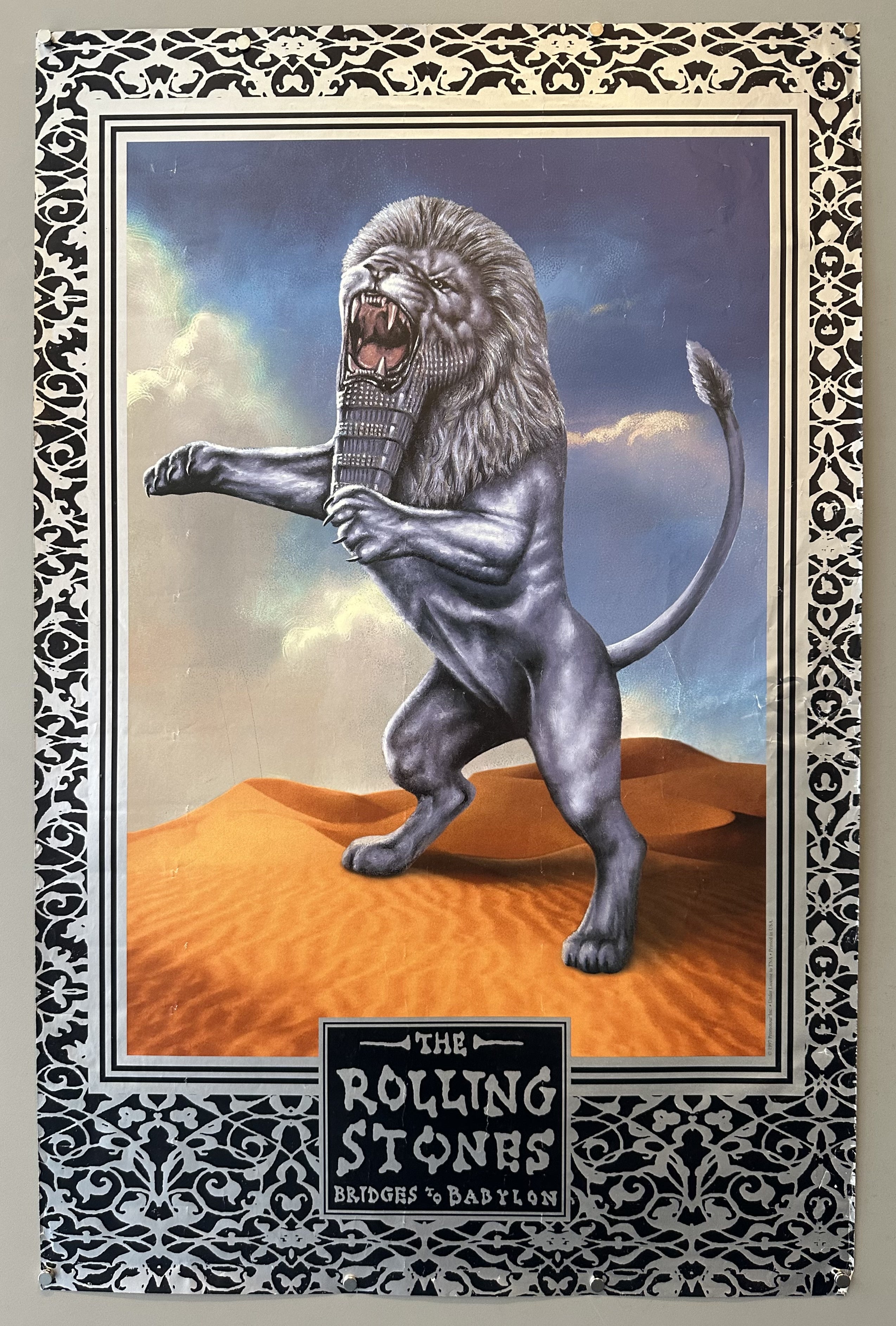 Lion in the desert roars and stands on two legs in promotional image for Rolling Stones album Bridges to Bablyon.
