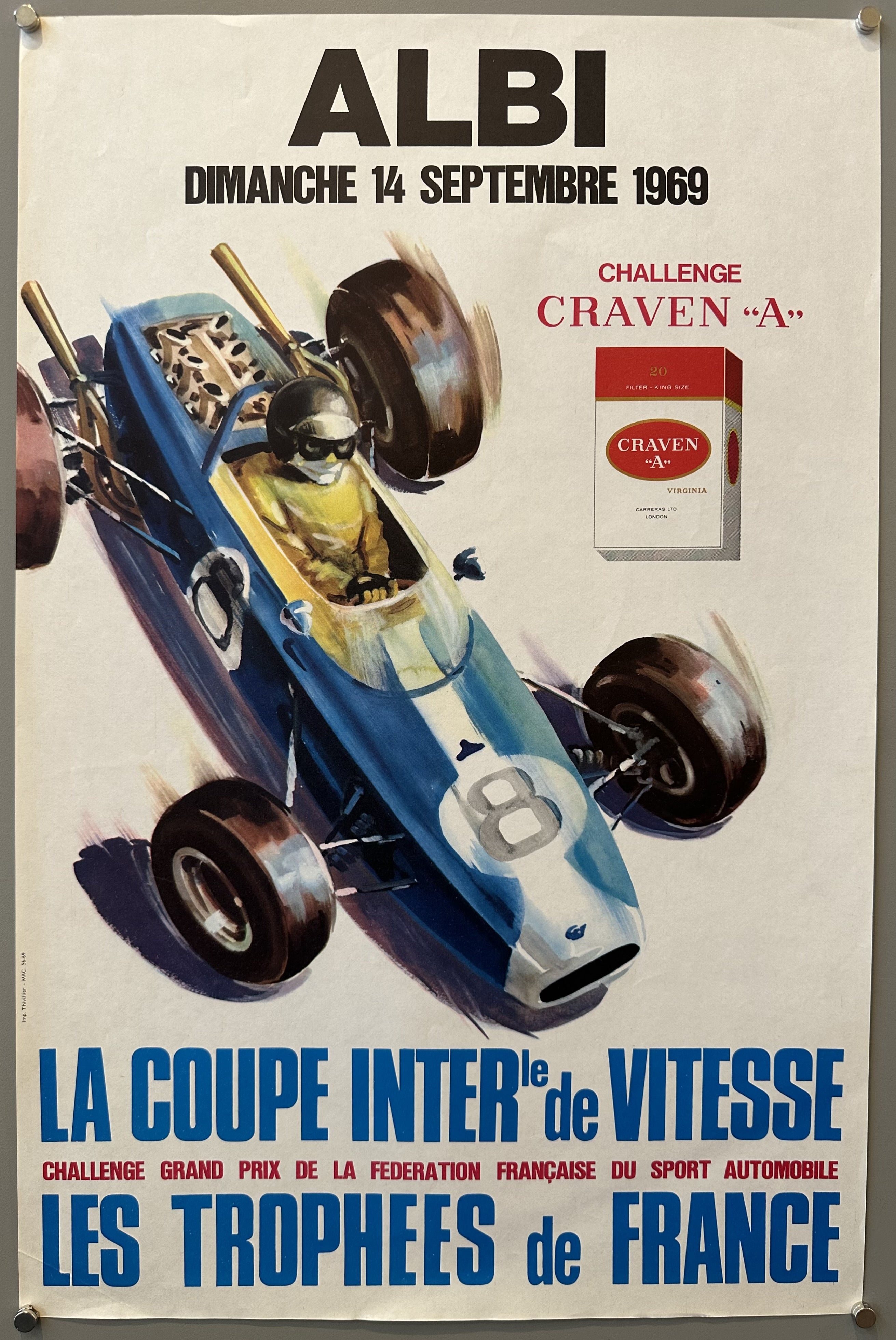 White poster with black, blue, and red text; illustrated race car driver with illustrated cigarettes on the right of him.