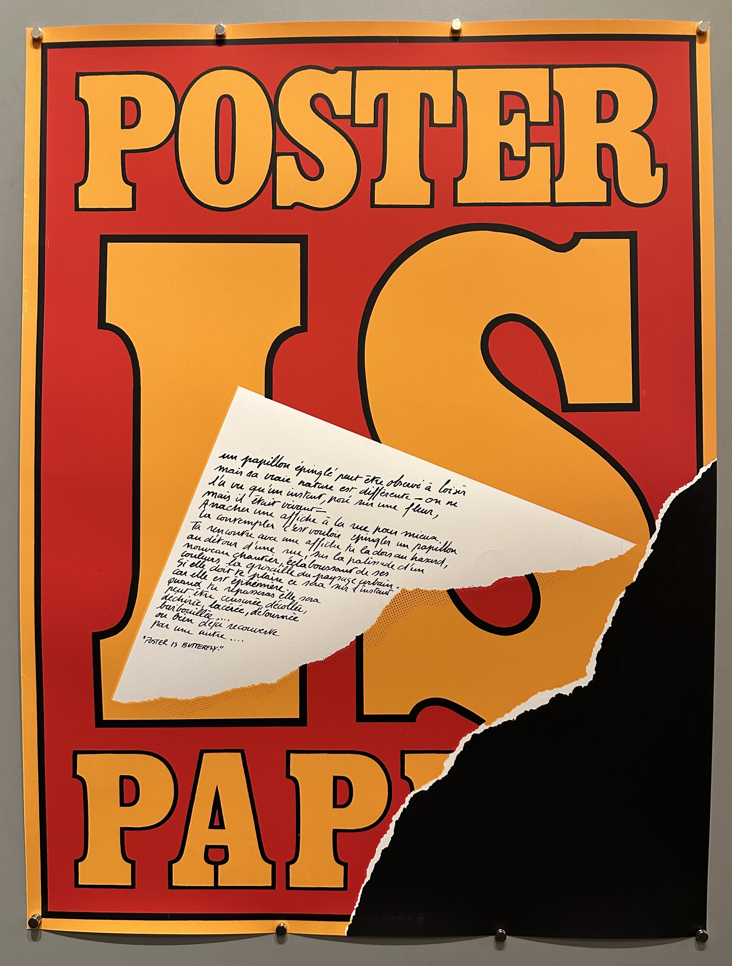 Red background with orange text peeled away along bottom right-hand side to expose a black backgound.