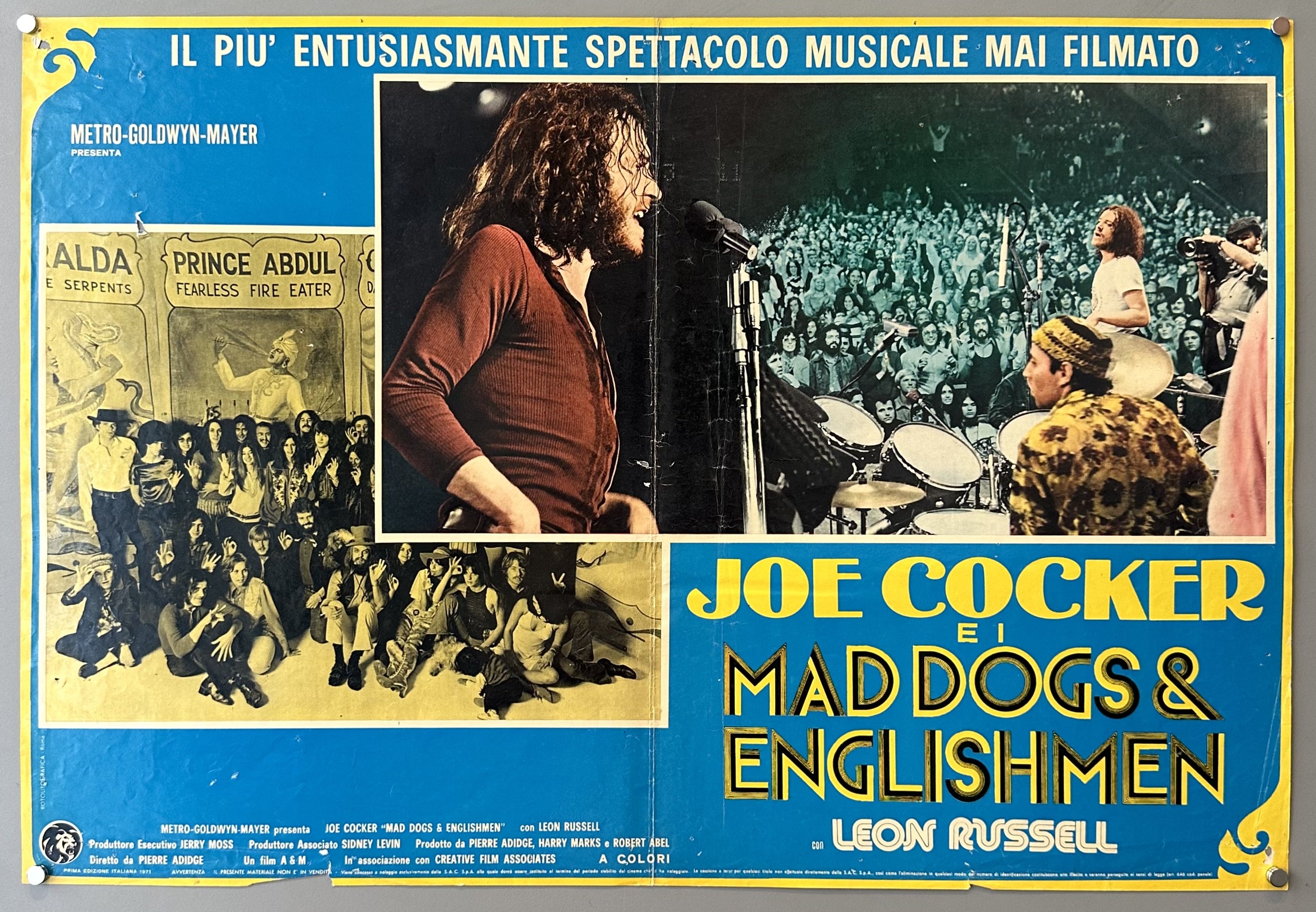 A movie poster for "Joe Cocker e i Mad Dogs & Englishmen" presented by Metro-Goldwyn-Mayer. The poster features a large image of Joe Cocker singing into a microphone on the right, and smaller inset images on the left depicting various scenes, including a group of people