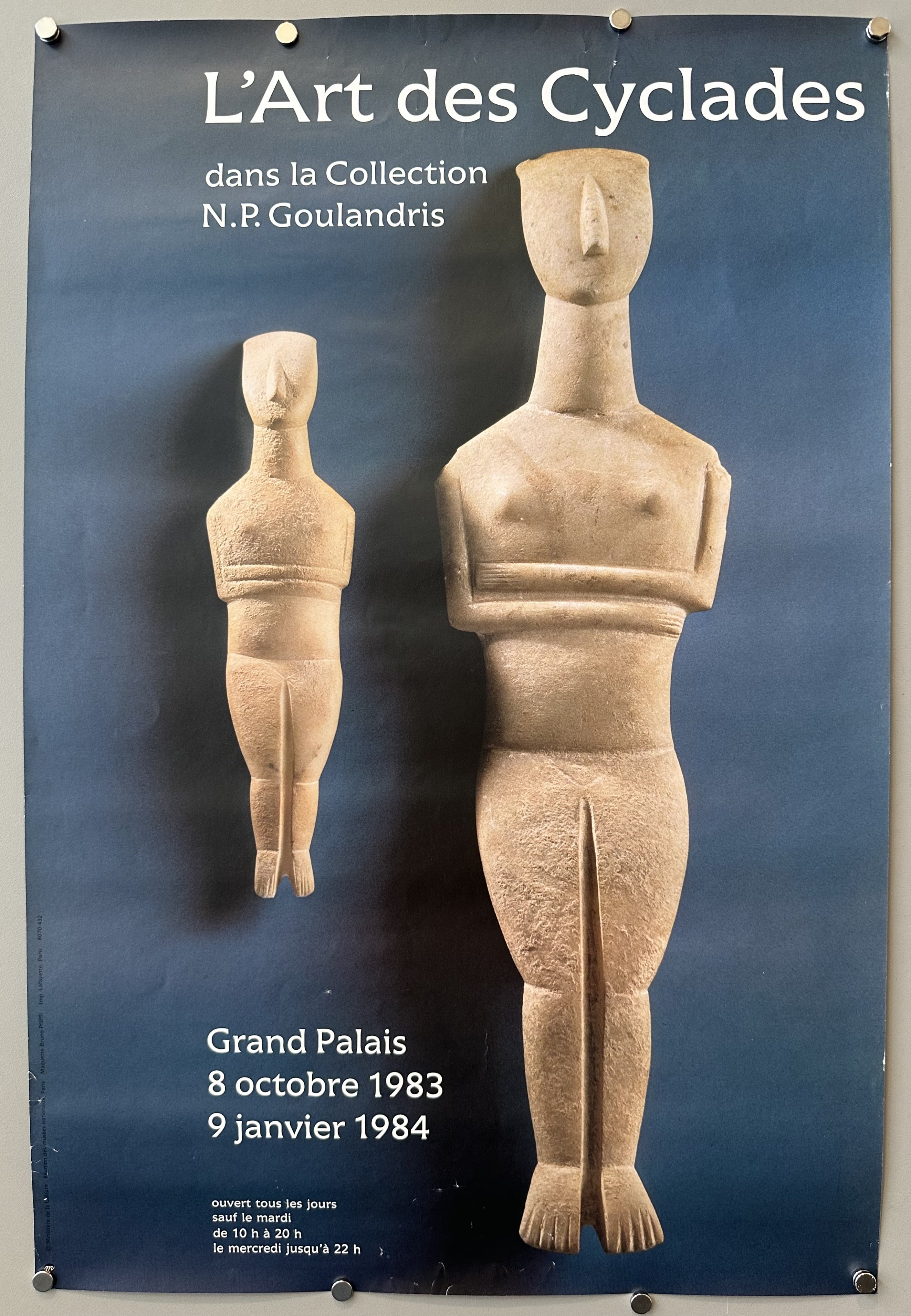 Two Cycladic statues against blue background to promote art exhibition.