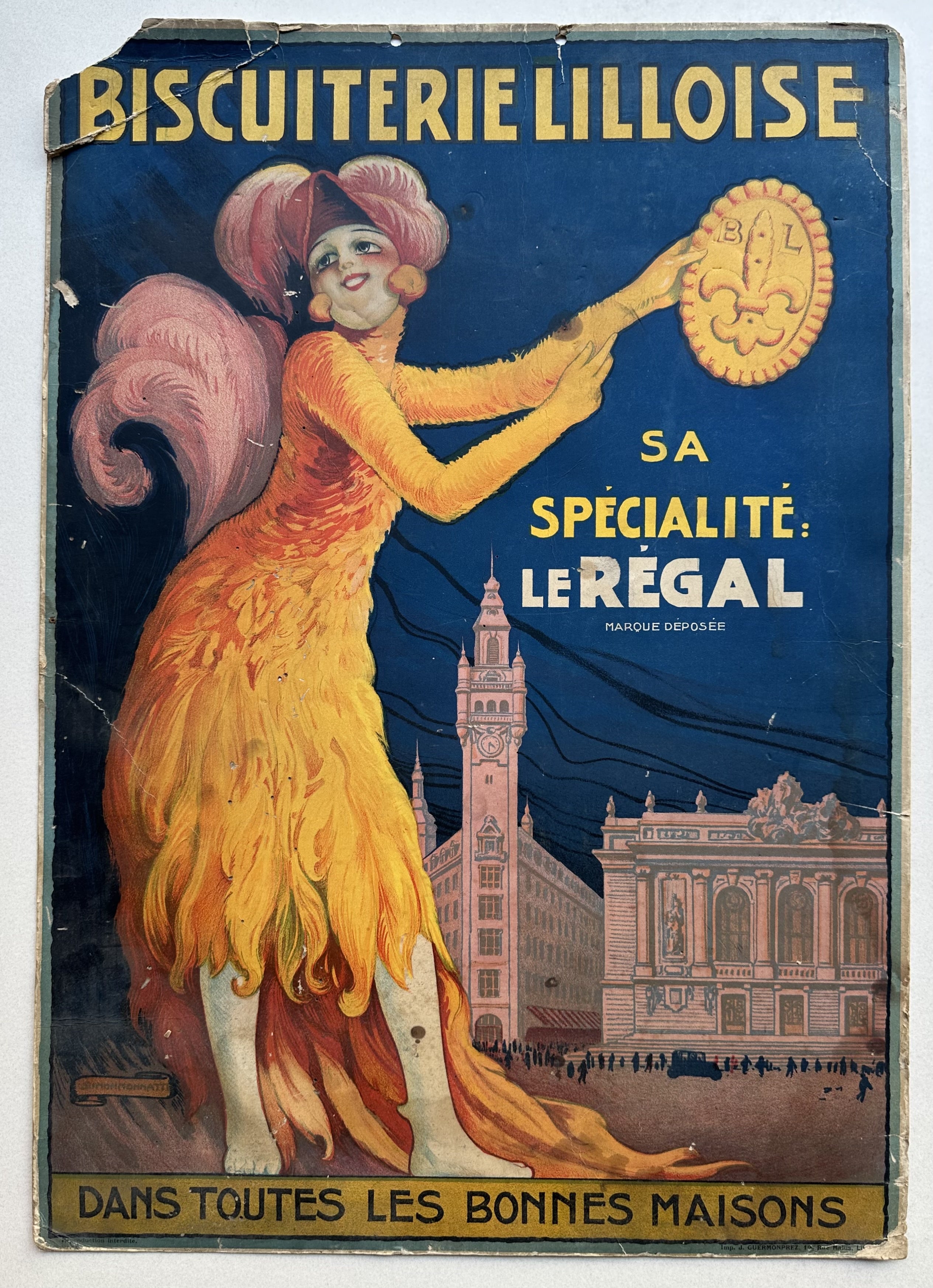Woman dressed in orange feathers holds a biscuit up against a blue background, back of cardboard poster is black text against beige background.