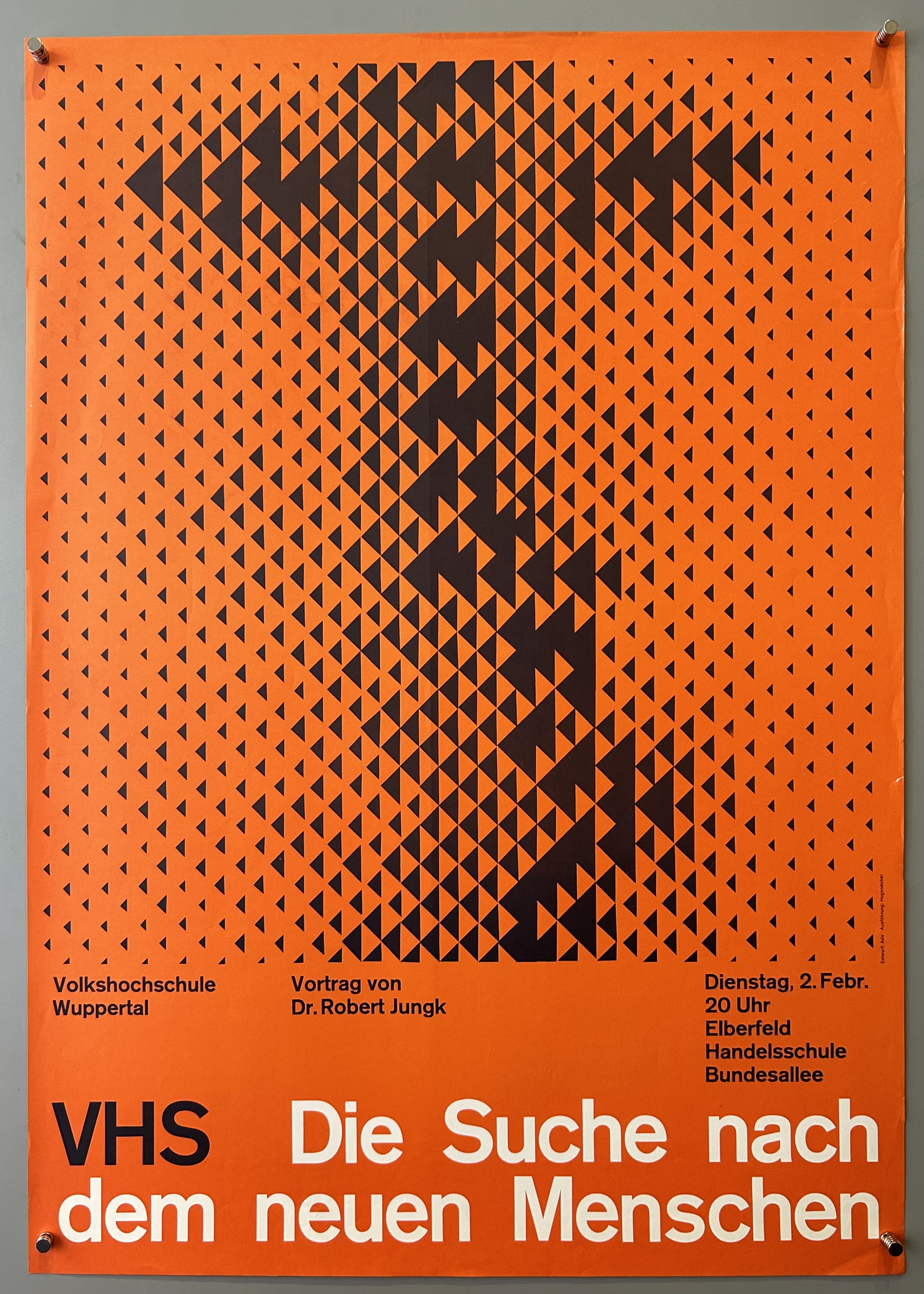 Orange poster with black triangles, black text underneath and white text along bottom.