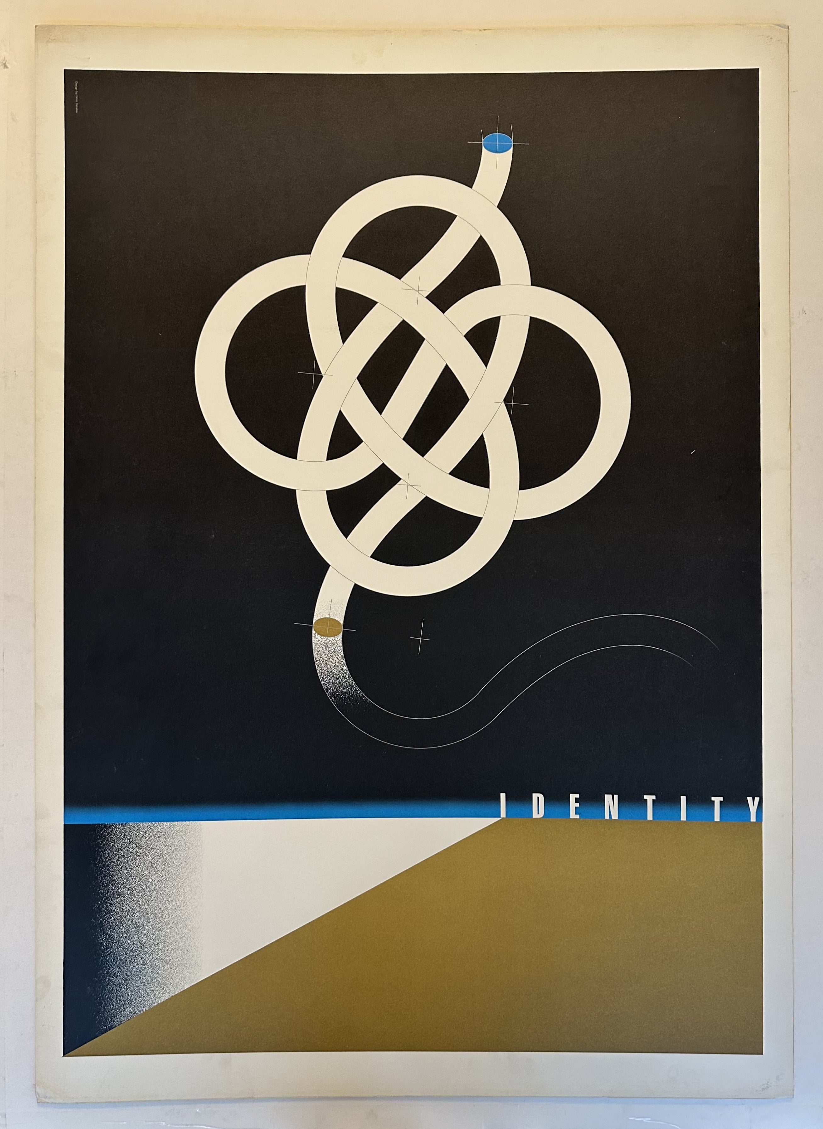 The poster features a black background with a white, stylized knot design in the center. The word "IDENTITY" is printed in white capital letters at the bottom center.