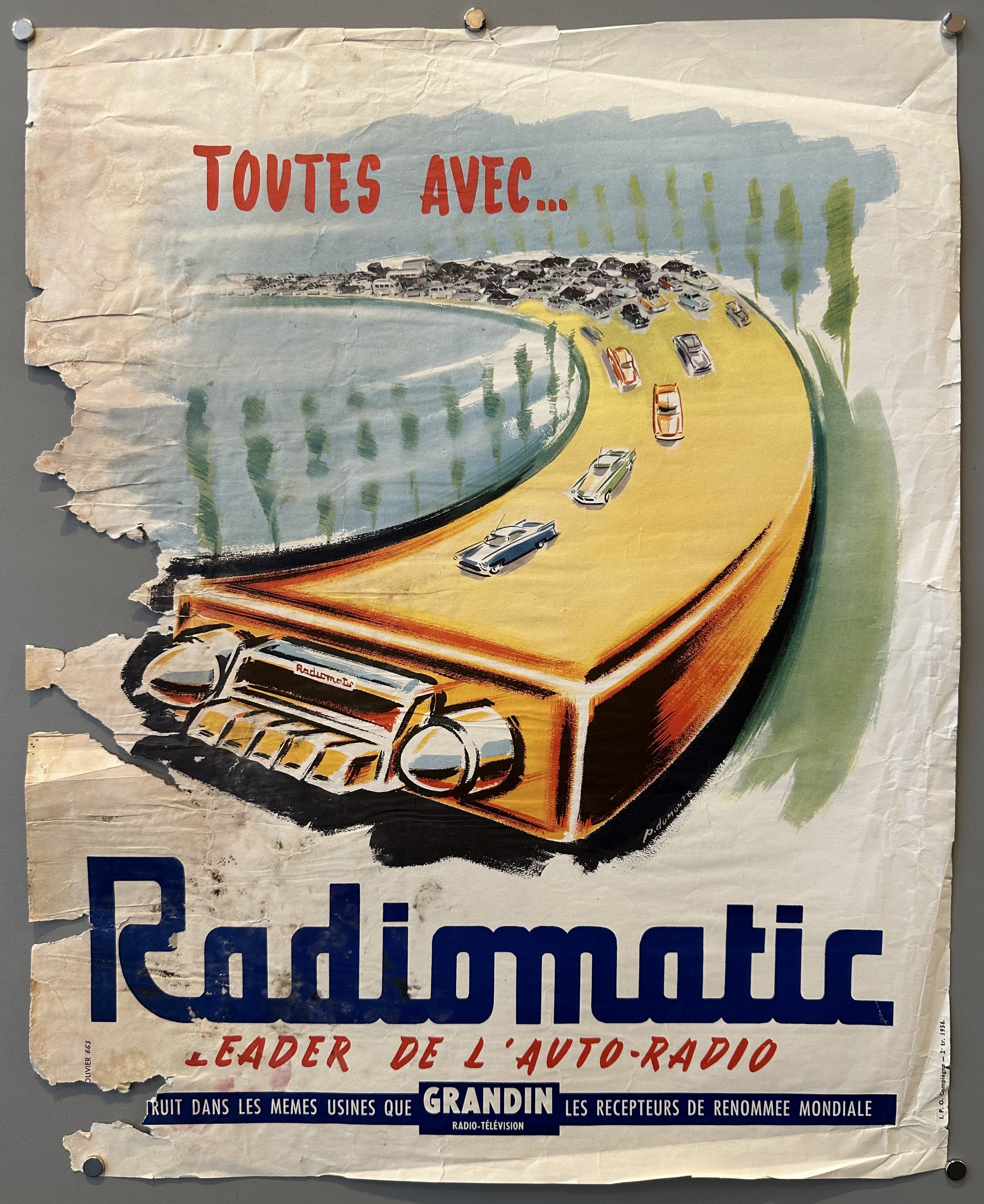 Car engine stretched to look like road with cars traveling on it as an advertisement for car radio
