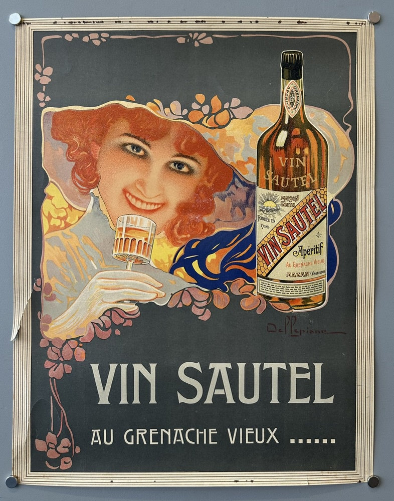 A smiling woman holding a glass of the aperitif, with a bottle of Vin Sautel prominently displayed