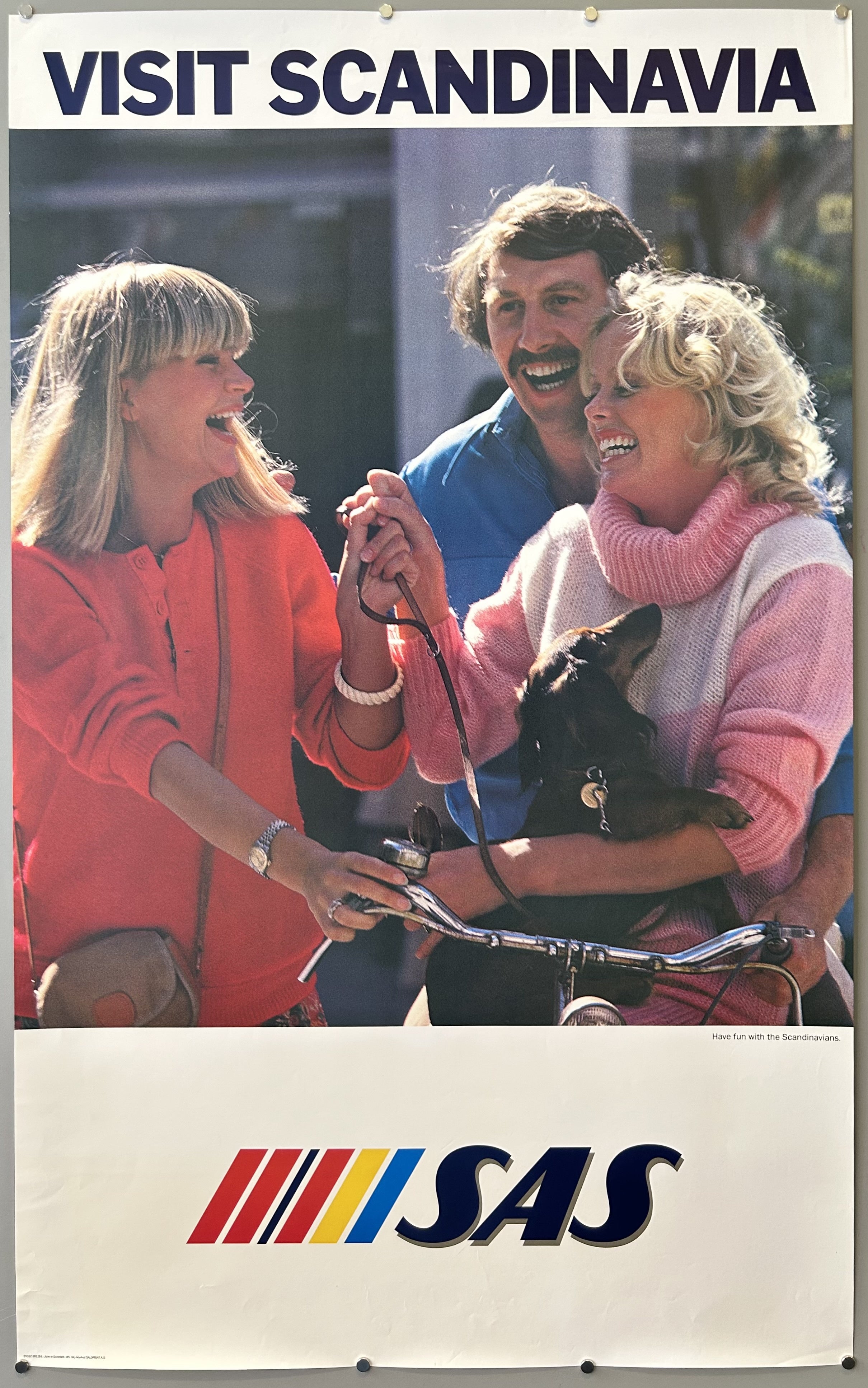Vintage travel poster from SAS featuring a photograph of three smiling people and a dachshund.