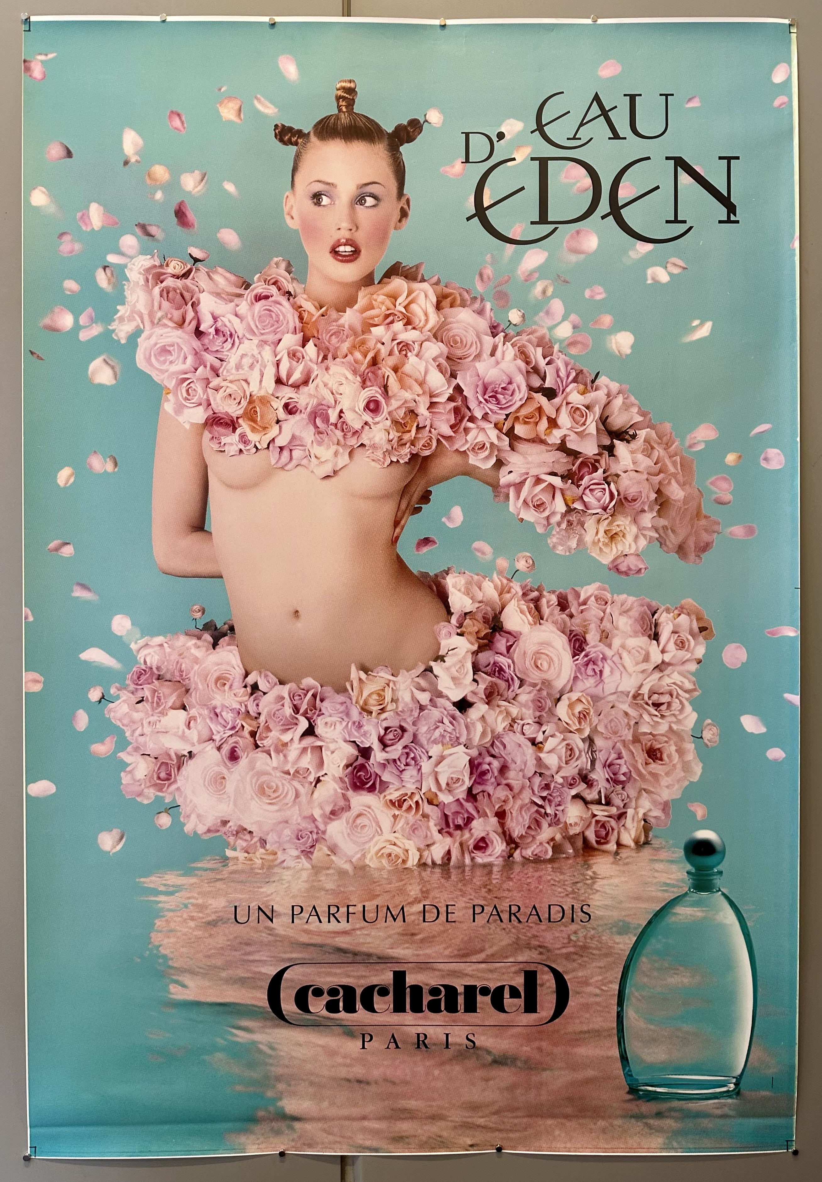 Photo realism poster of girl covered in roses in water for perfume Eau d'Eden by Cacharel.