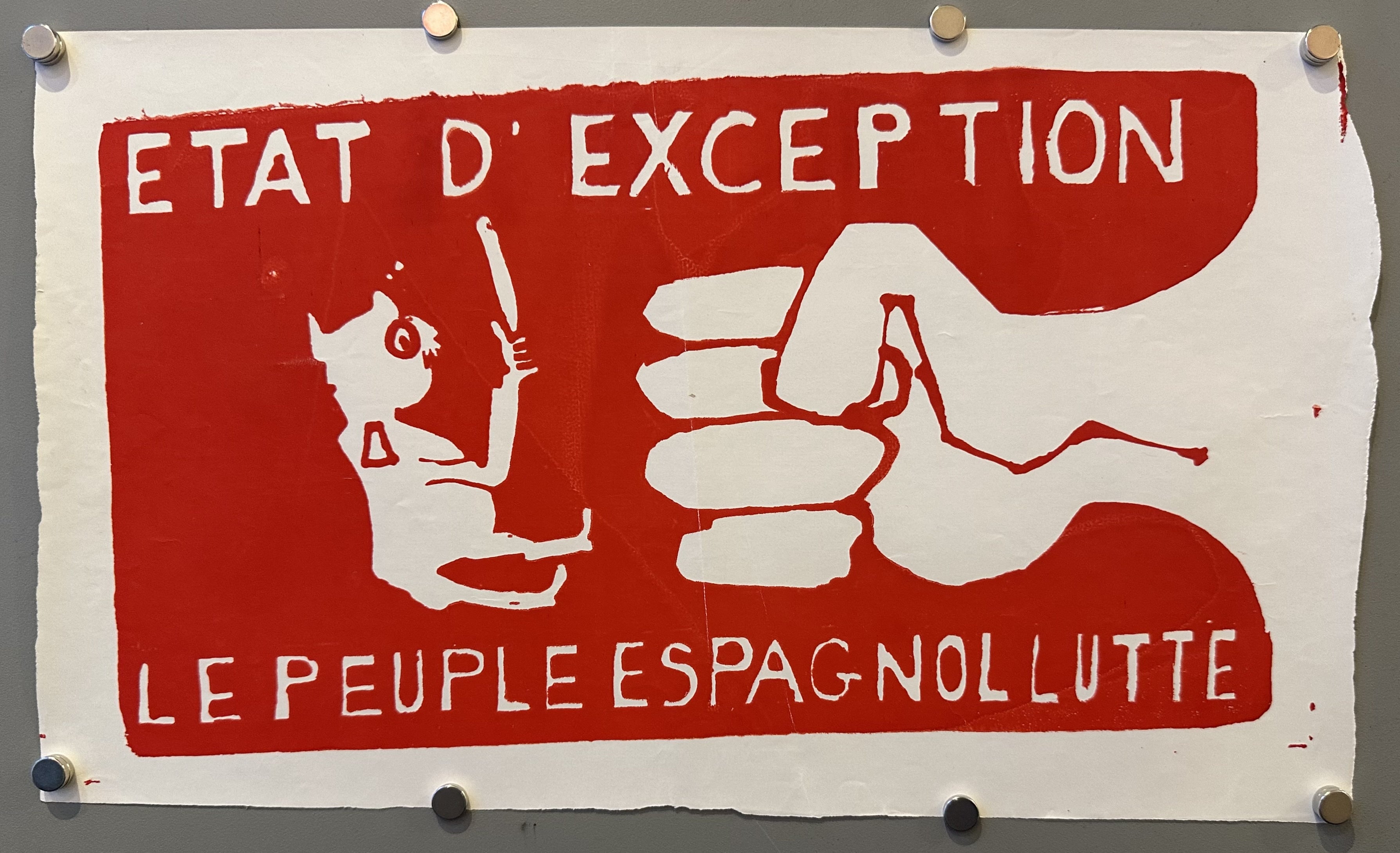 A fist hits a small character in this horizontal and red French poster produced during May 1968.