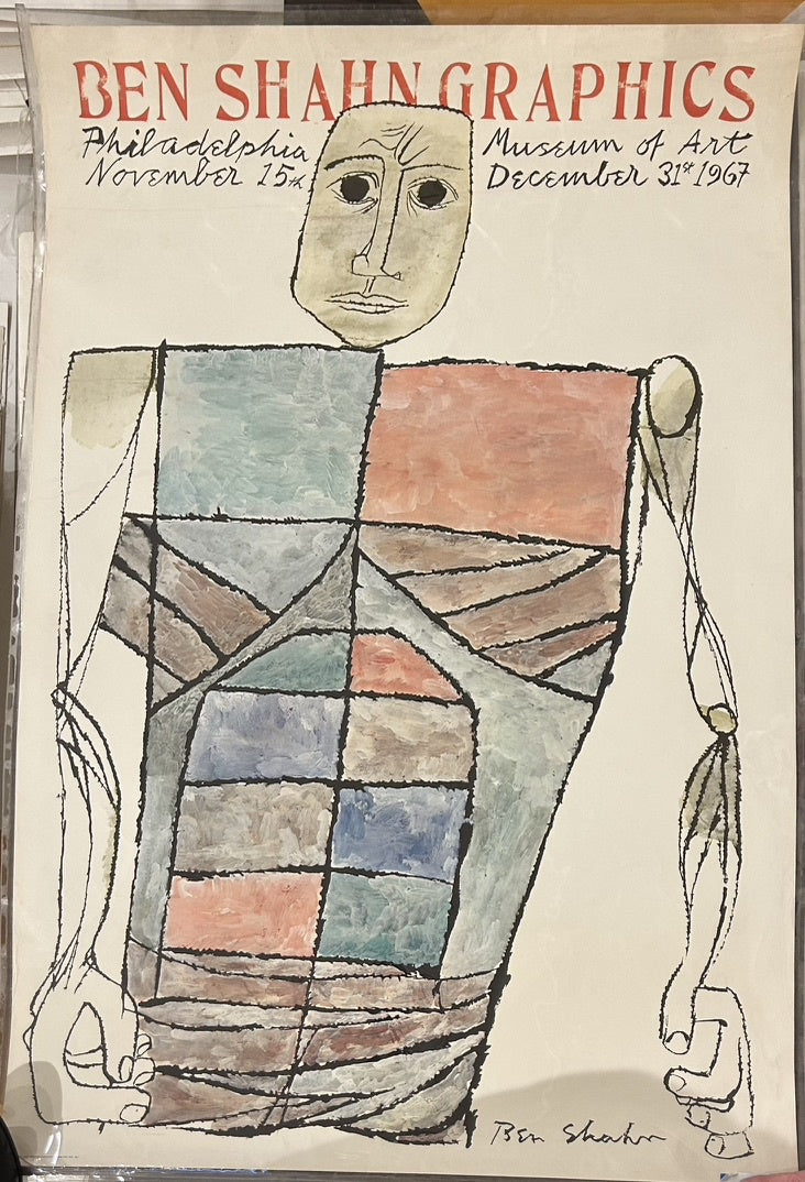 An exhibition poster for "BEN SHAHN GRAPHICS" at the Philadelphia Museum of Art, featuring a stylized abstract figure. The figure has a mask-like face and a body composed of colorful, geometric shapes resembling architectural elements.