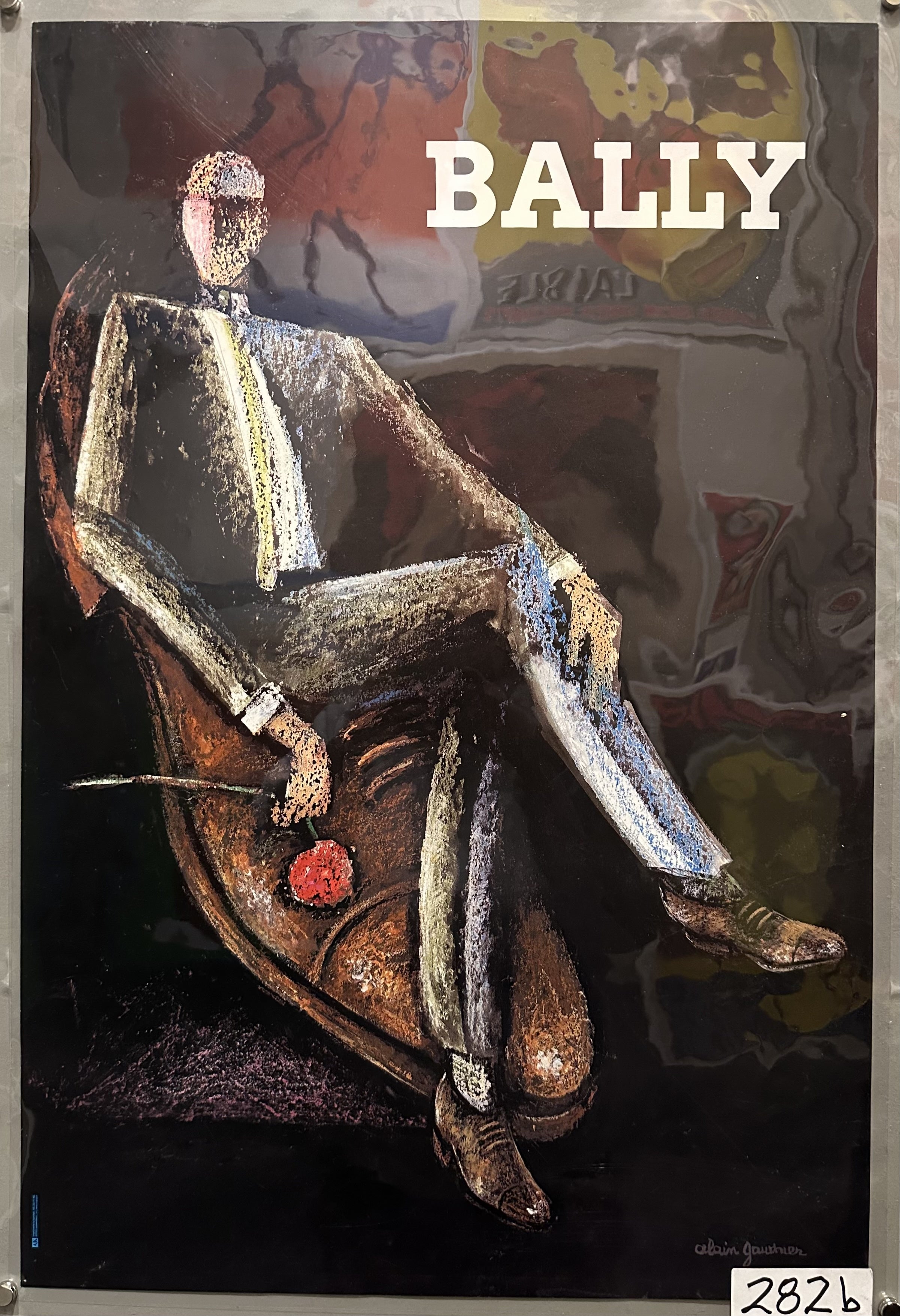 A man lounges on a shoe in Bally advertisement.