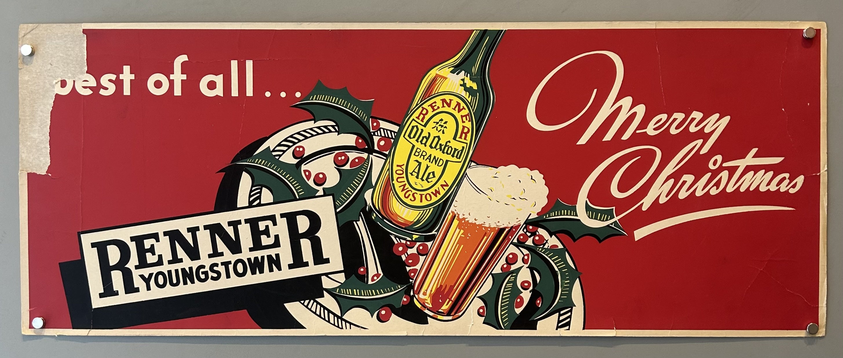 An advertisement for Renner's Old Oxford Brand Ale, featuring festive holiday imagery. The ad includes a bottle and a glass of the ale, surrounded by holly and berries, with the text "Merry Christmas" and "best of all..." The text "Renner Youngstown" is prominently displayed.