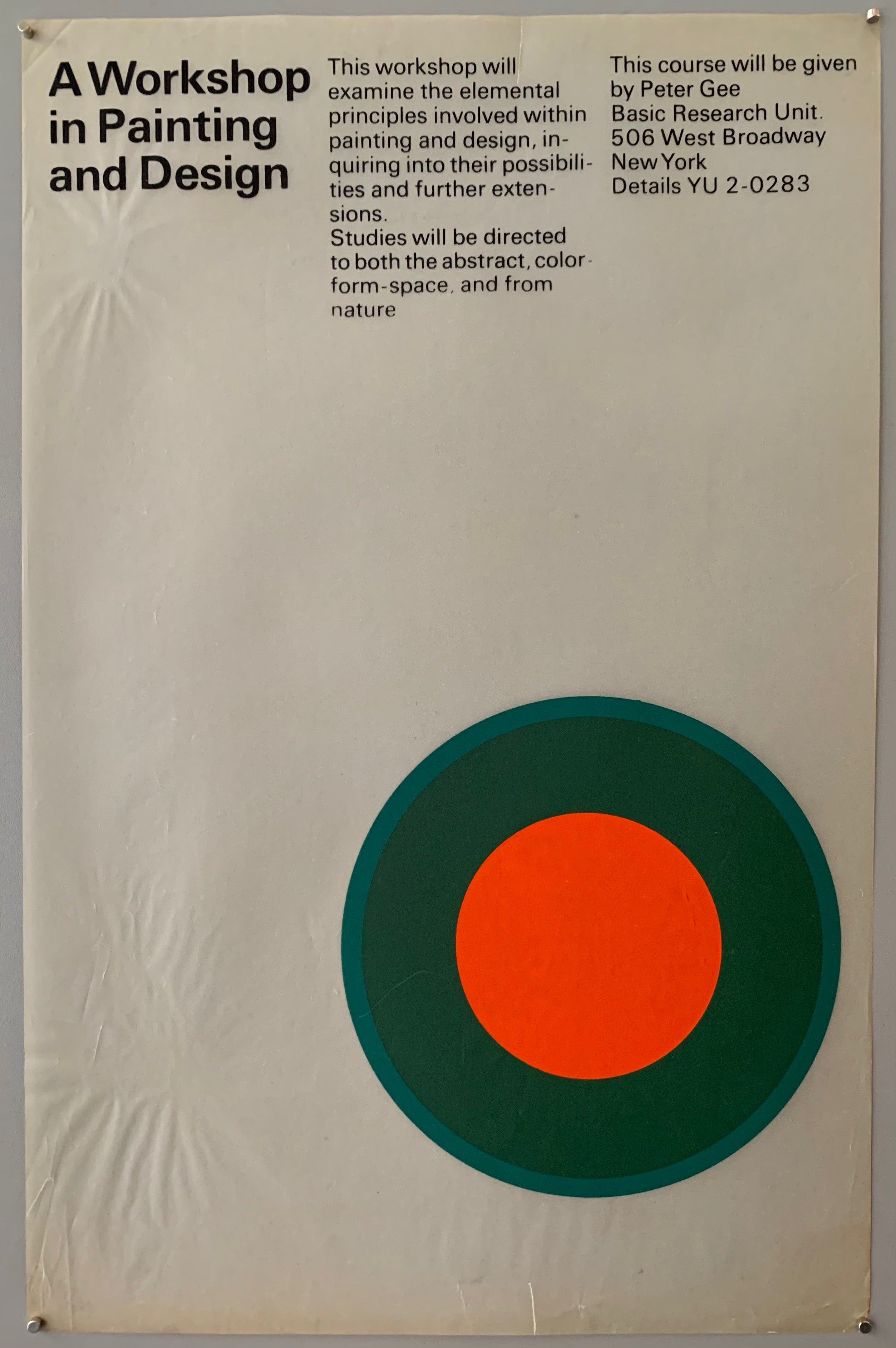 White poster with a cyan and orange target