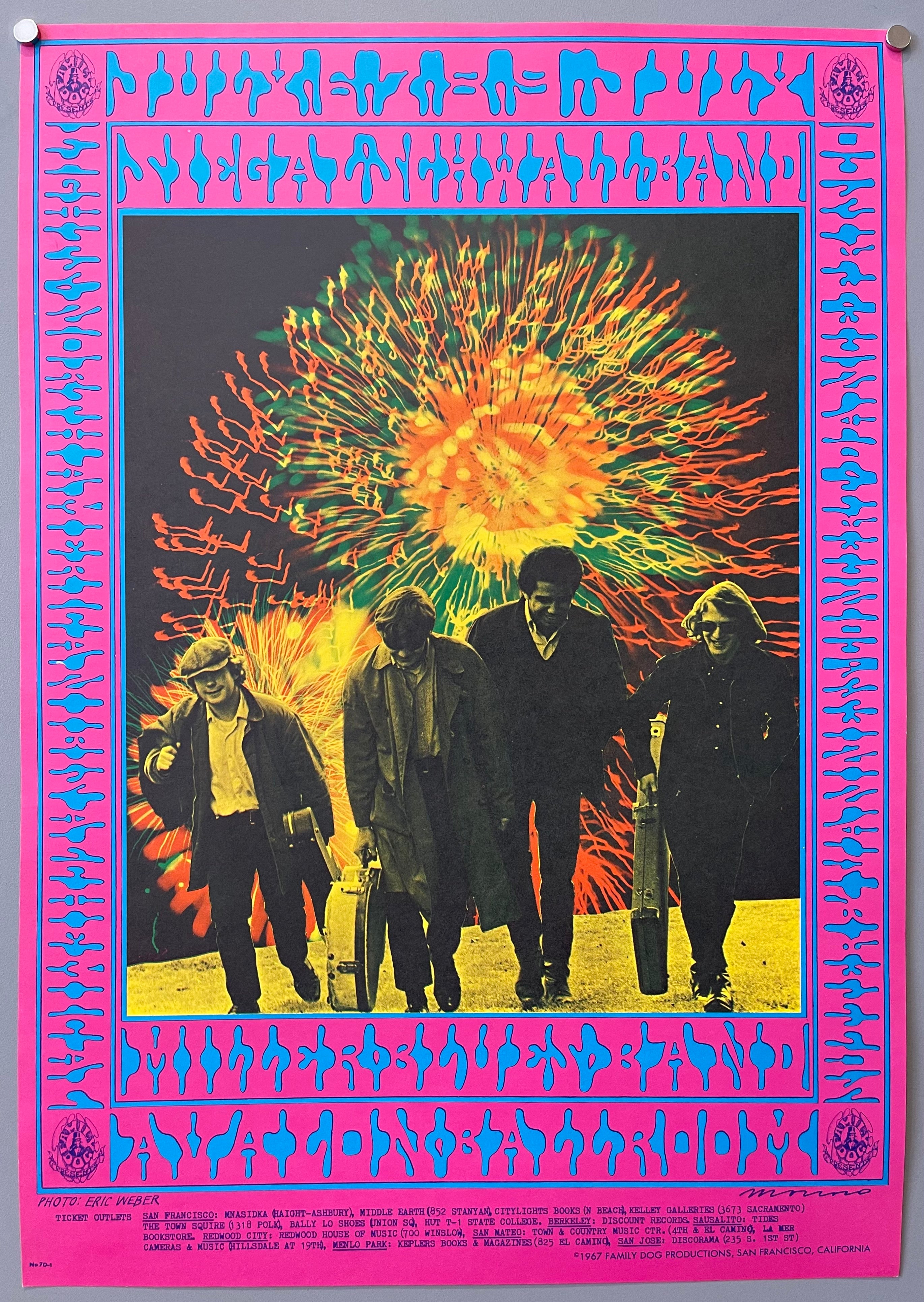 poster of a band in front of fireworks