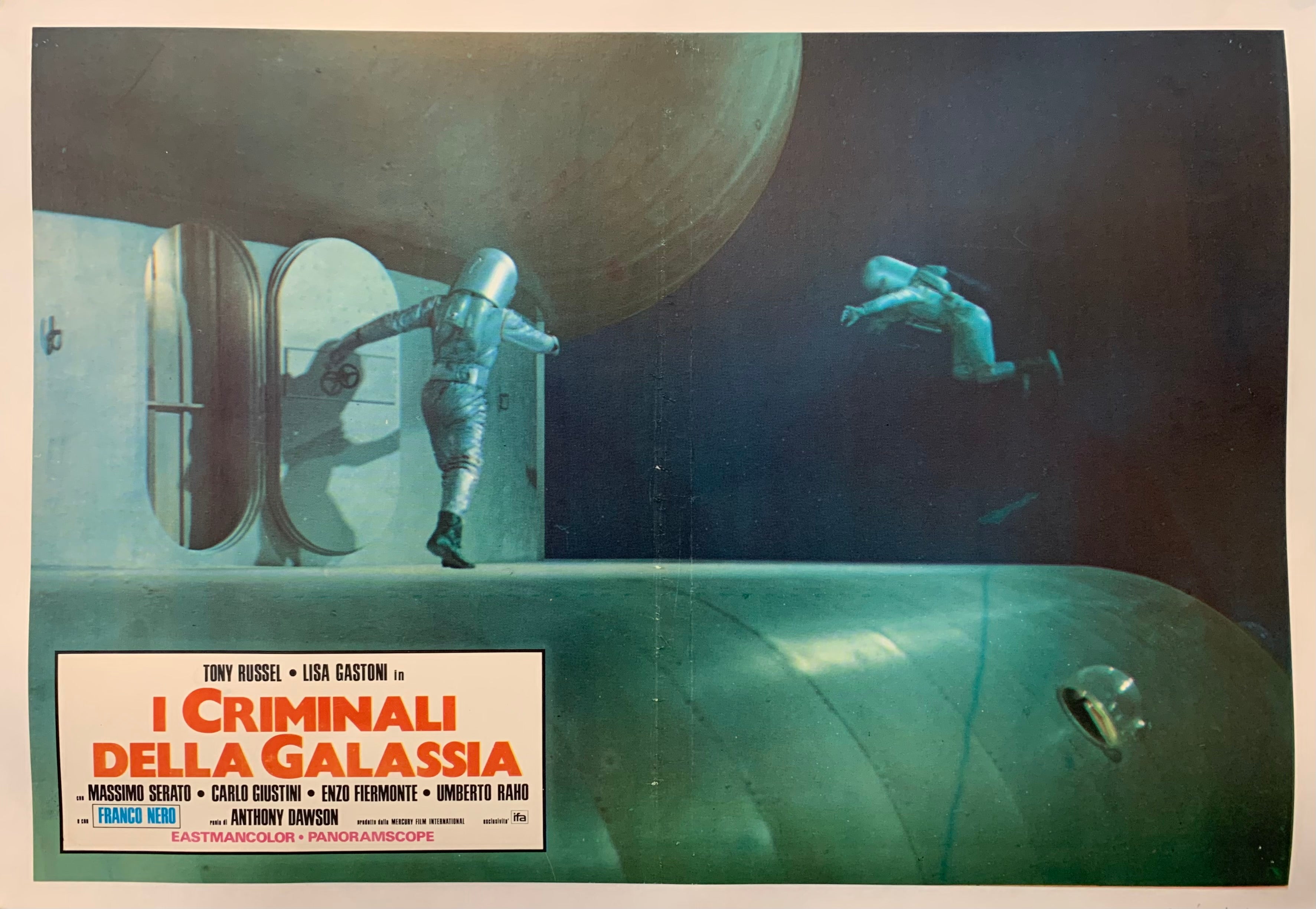 Two astronauts are on a spaceship. The text is on the bottom left in red.