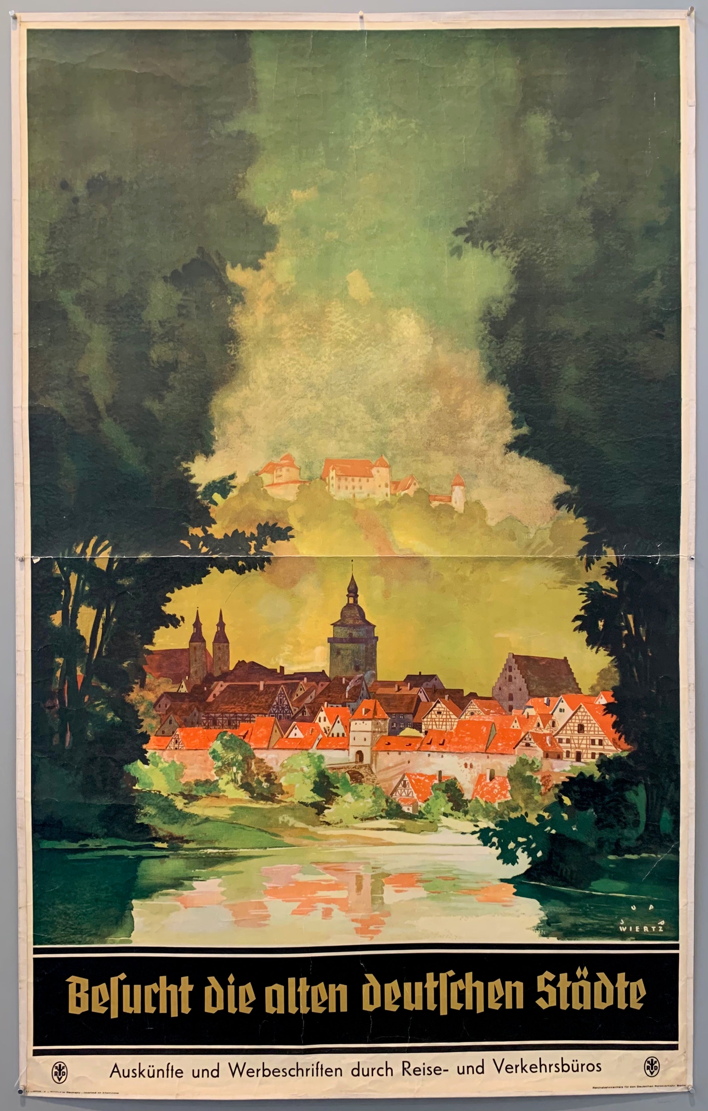 Published by the information and advertising through travel and traffic offices this poster encourages travel to old german cities. Pictured are traditional german houses in the town peeking through lush greenery surrounding a lake.