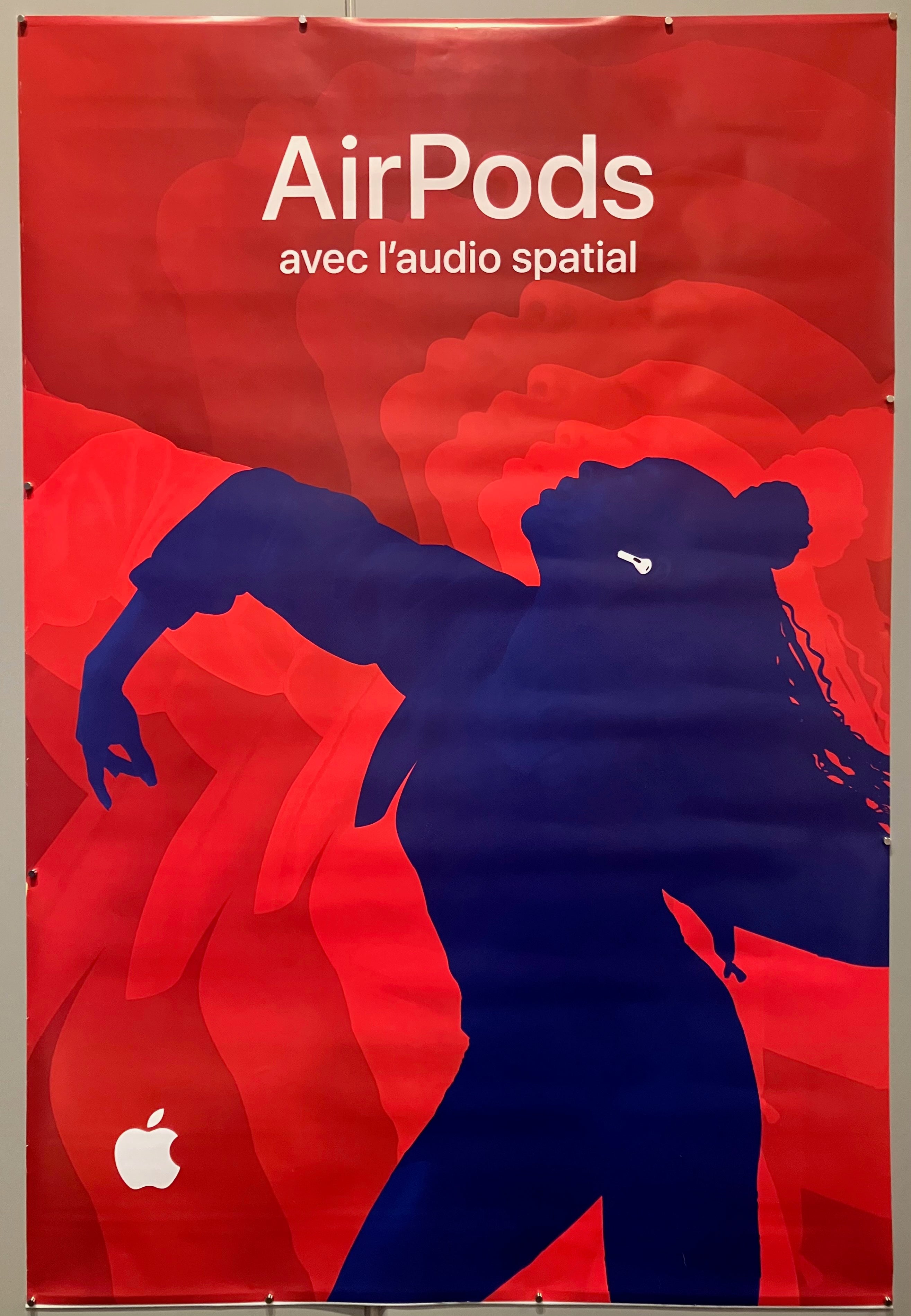 69x47 french apple advertisement for 3rd generation airpods with spatial audio featuring navy blue silhouette of person dancing with white airpods and red background