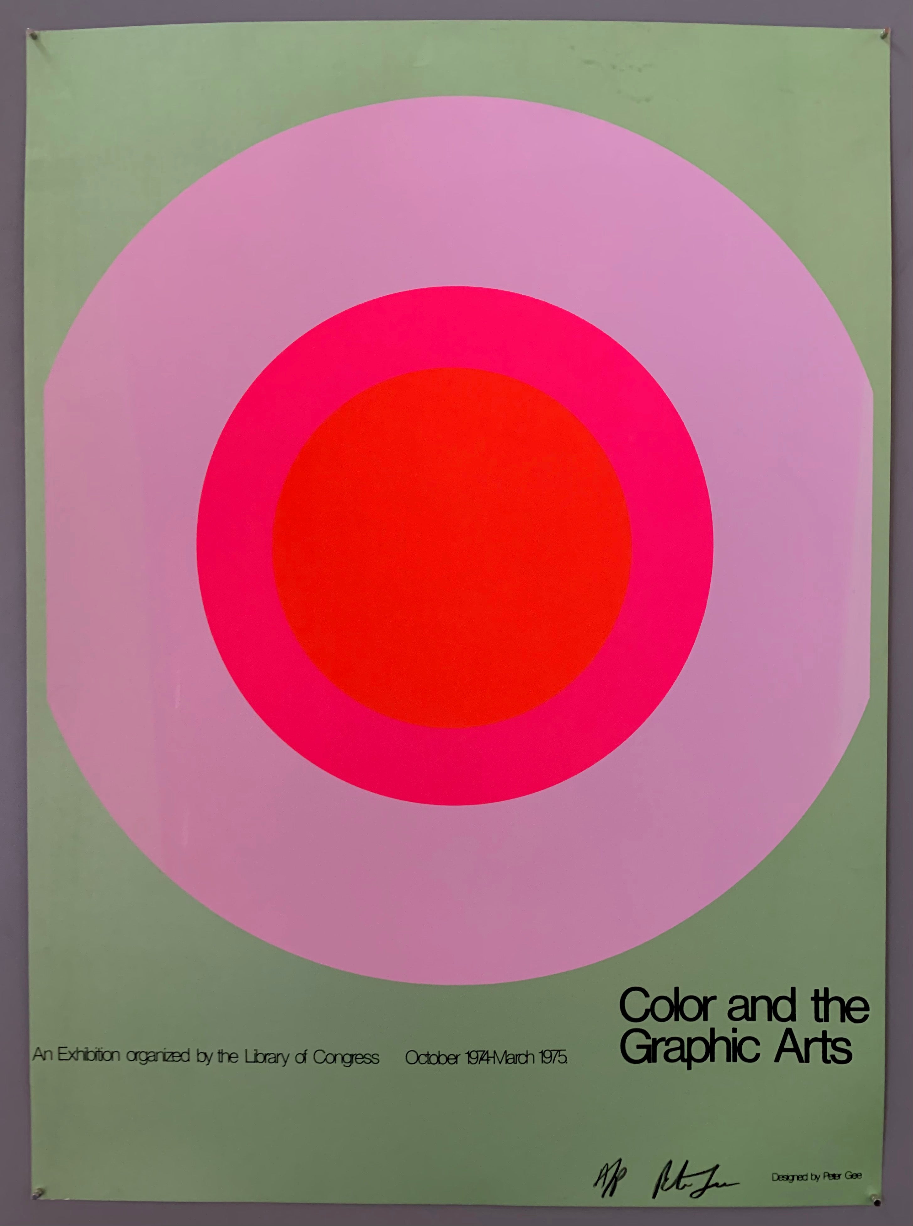 A large target takes up the center of the page, with the writing small beneath it. The colors are mint green, lilac, hot pink, and neon orange.