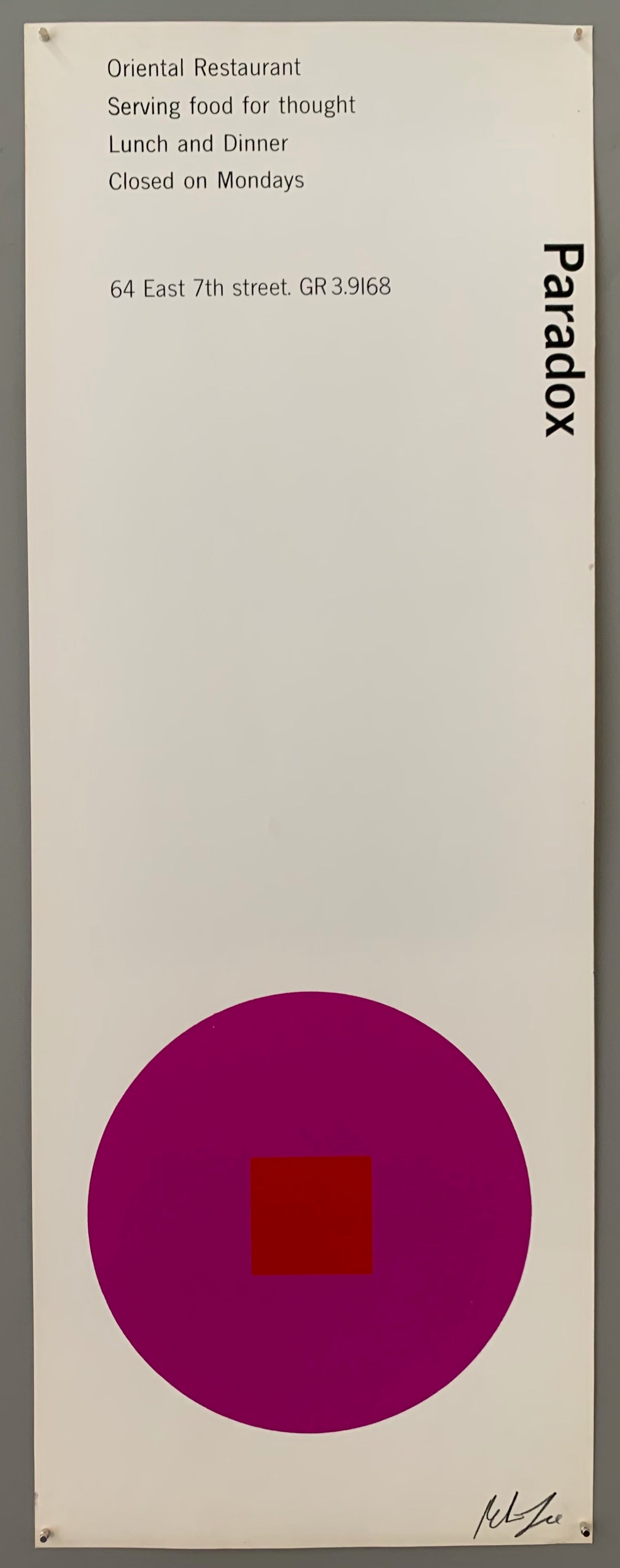 A purple circle with a red square on white paper.