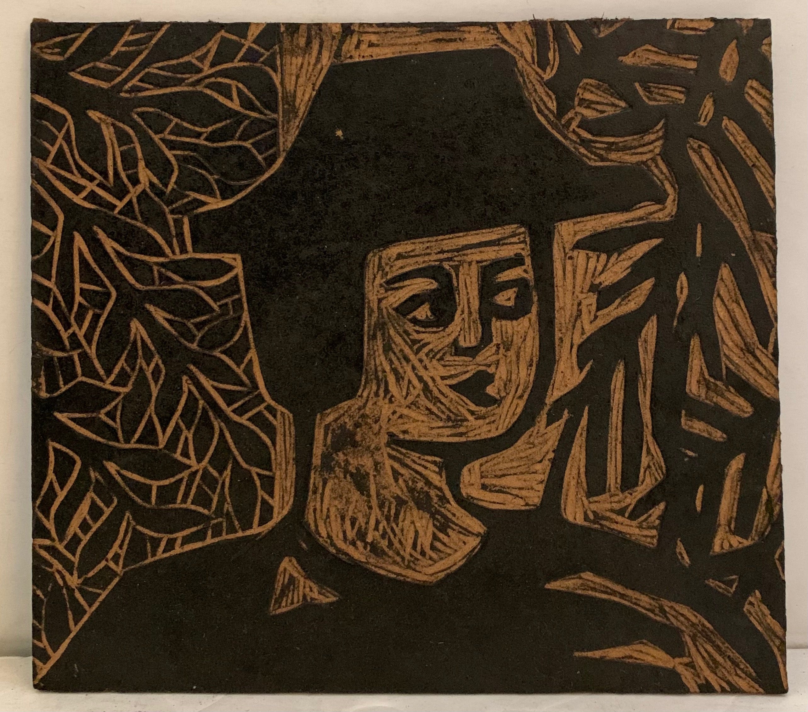 Woodblock of a man in a heat in front of a wall of leaves