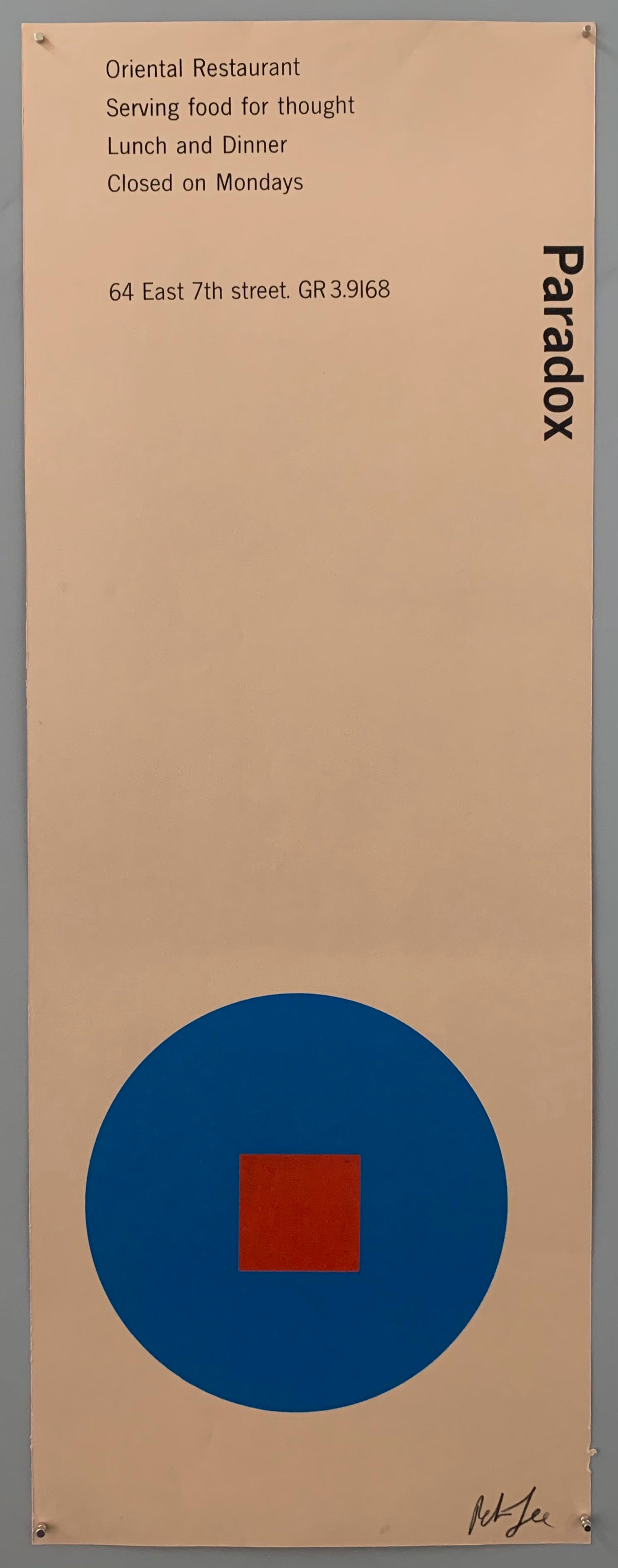 A blue circle with a red square on light brown paper.