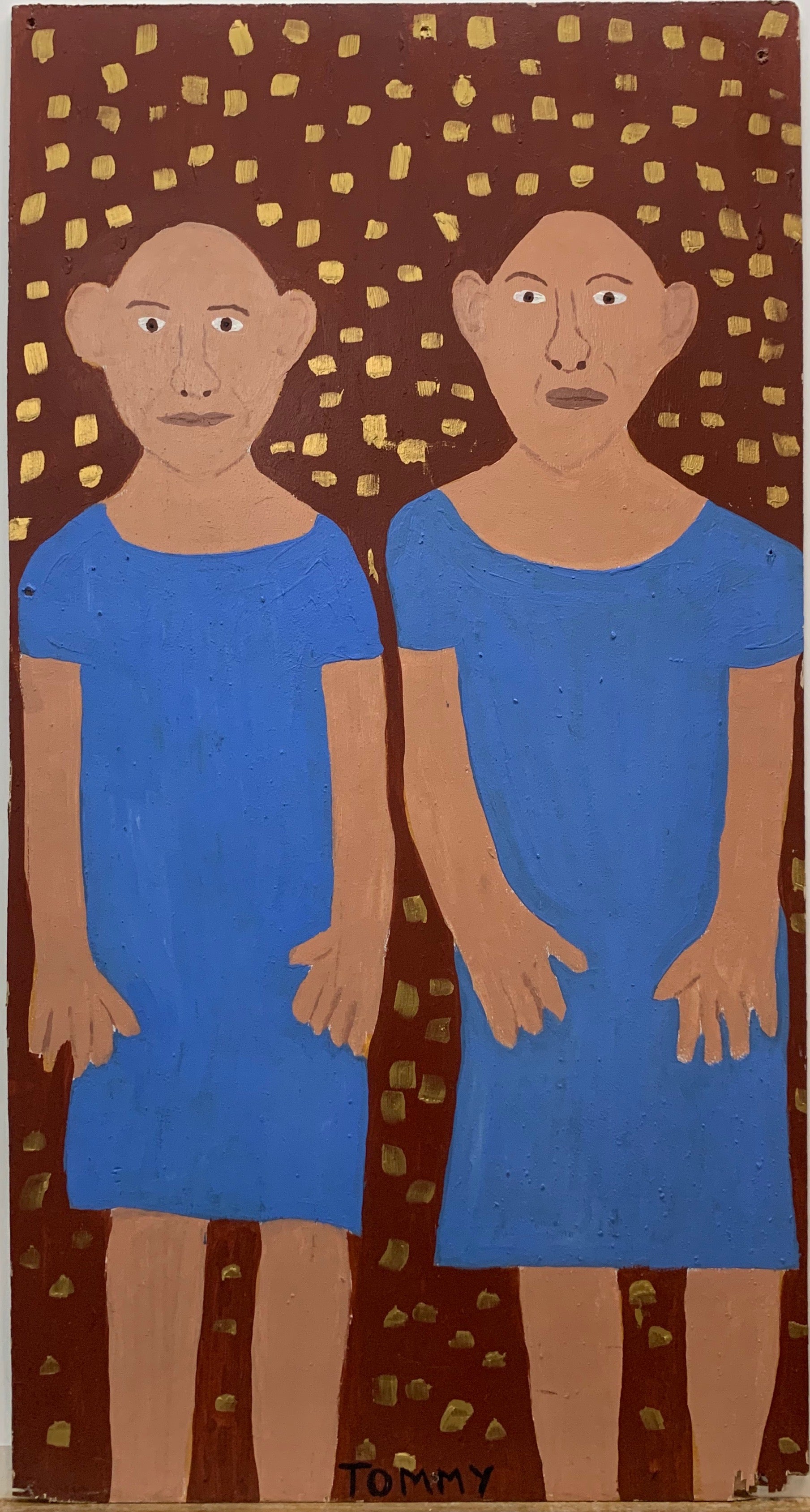 Portrait of twins Pip and Flip, both bald and wearing matching blue dresses.