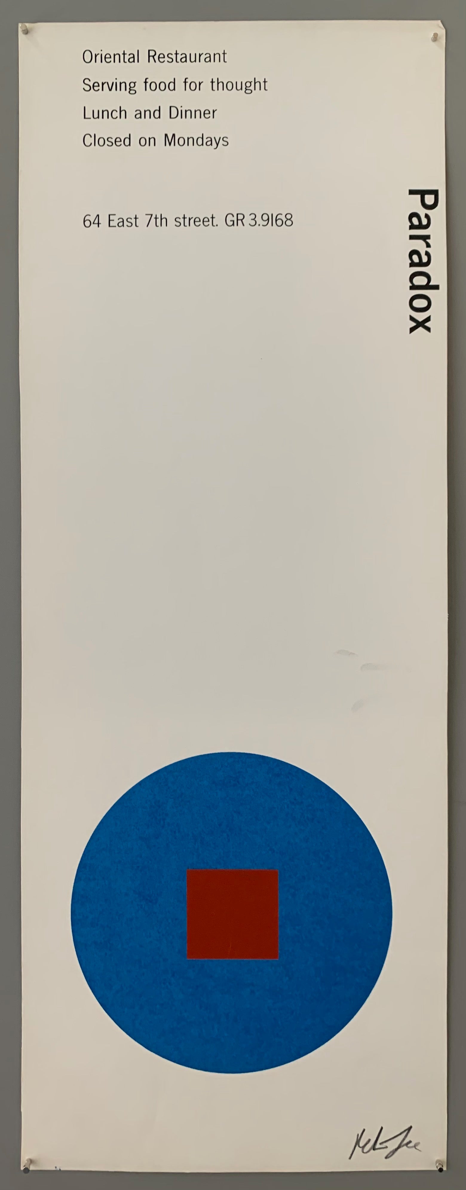 A blue circle with an red square on white paper.