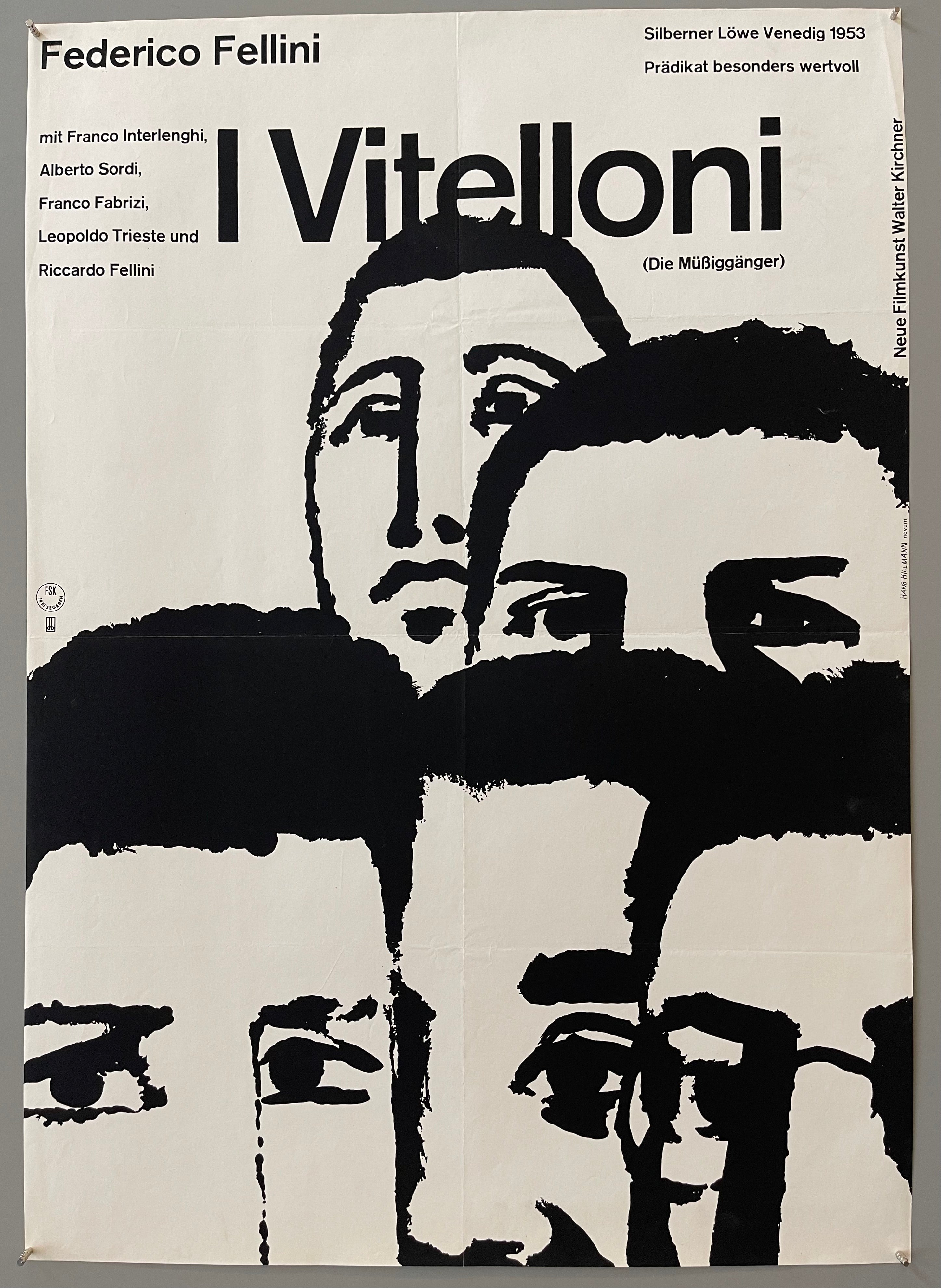 Close-up of the heads of five illustrated men under the film title.
