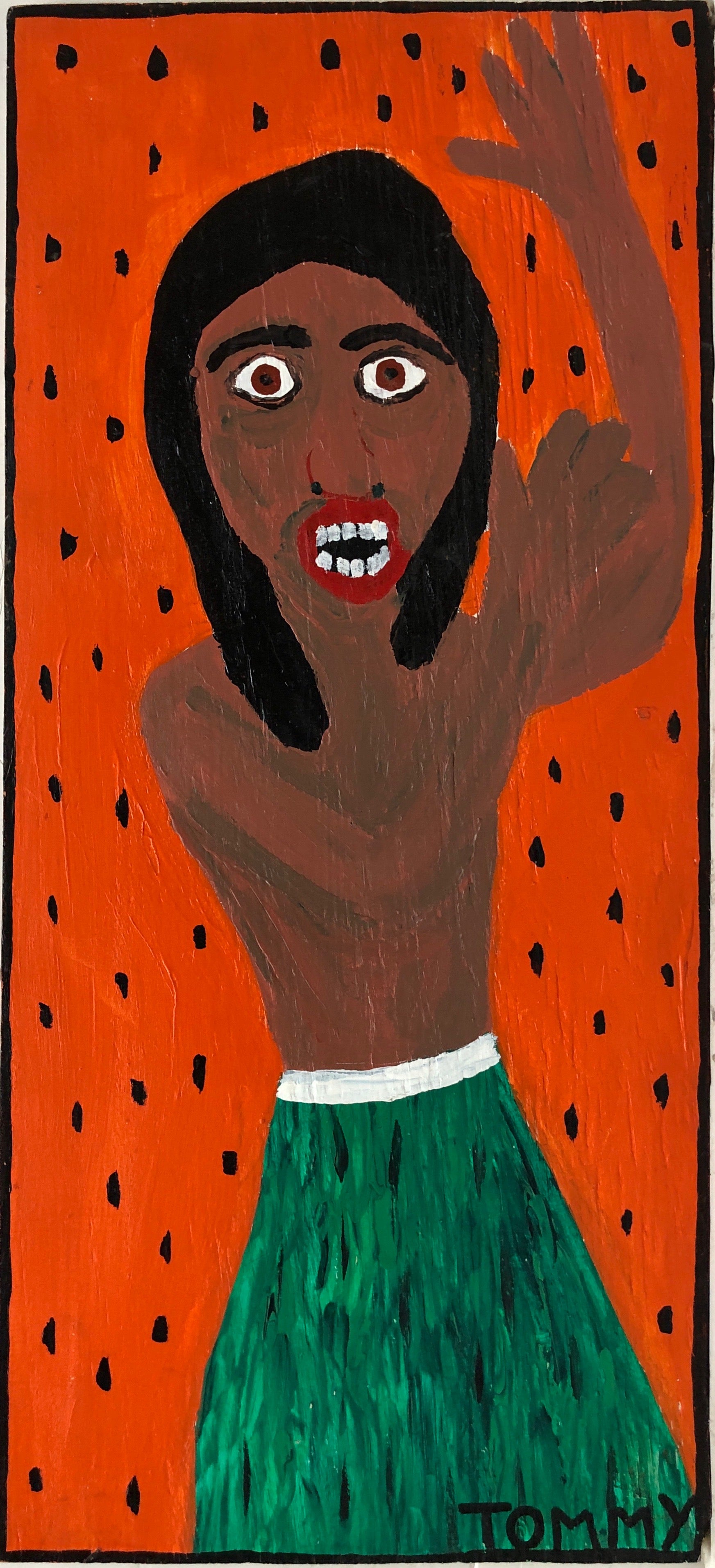 Portrait of a man in a grass skirt raising his hands in the air.