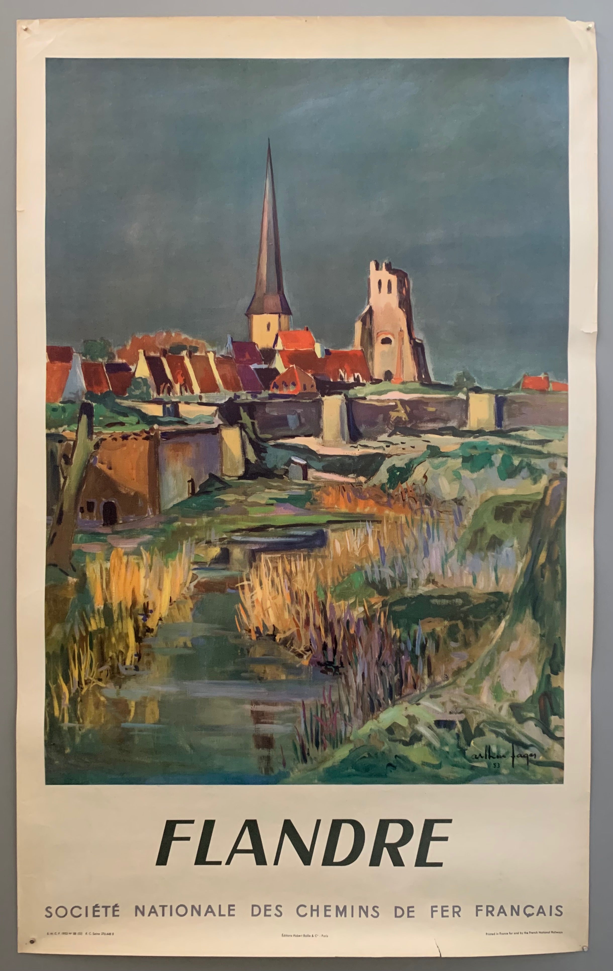 An impressionist image shows a dark color scheme with a red and white town. There are yellow reeds and the water matches the teal of the land. The border s white with black writing.