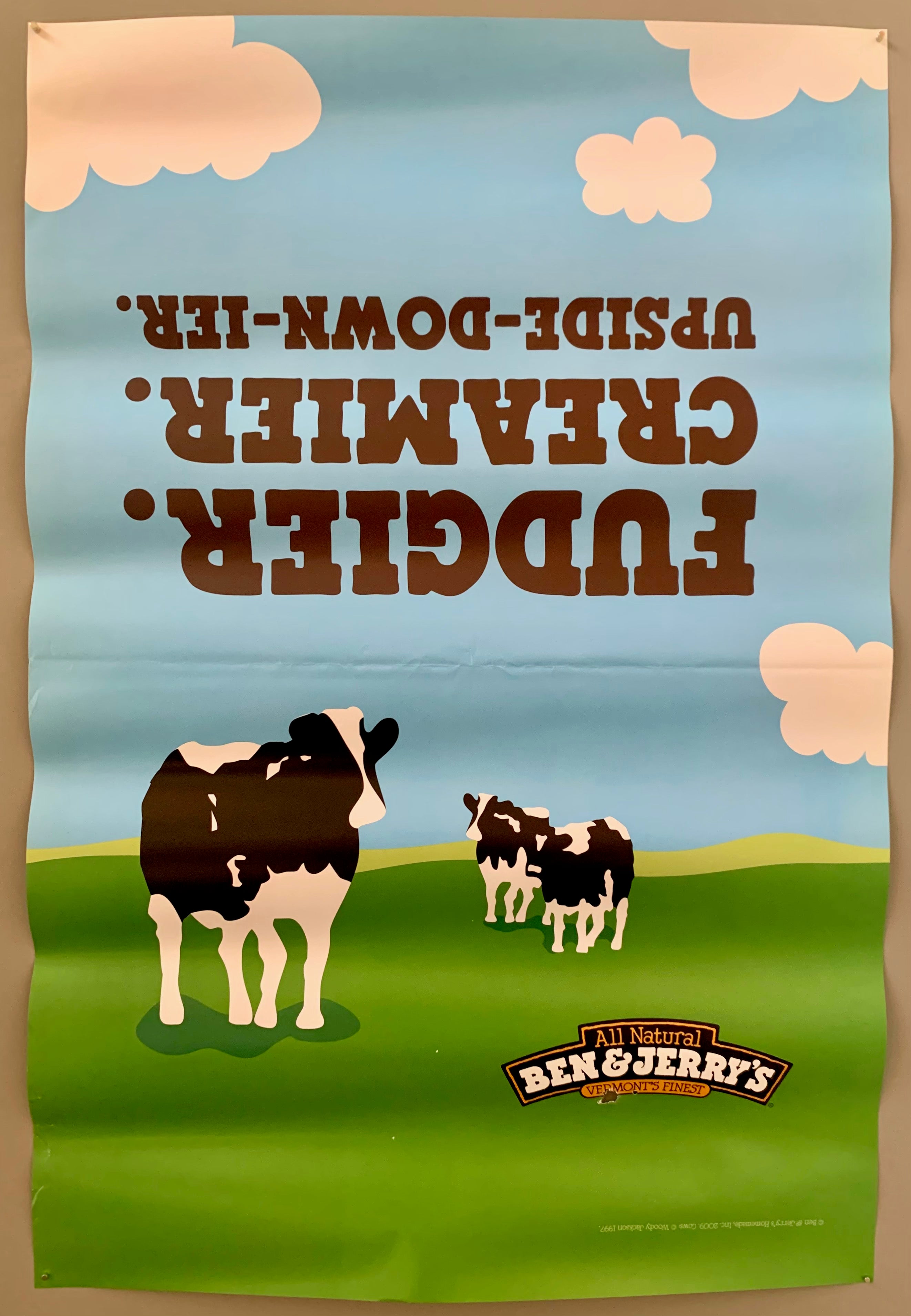 poster of the Ben&Jerry cows on a green field under a blue sky with clouds