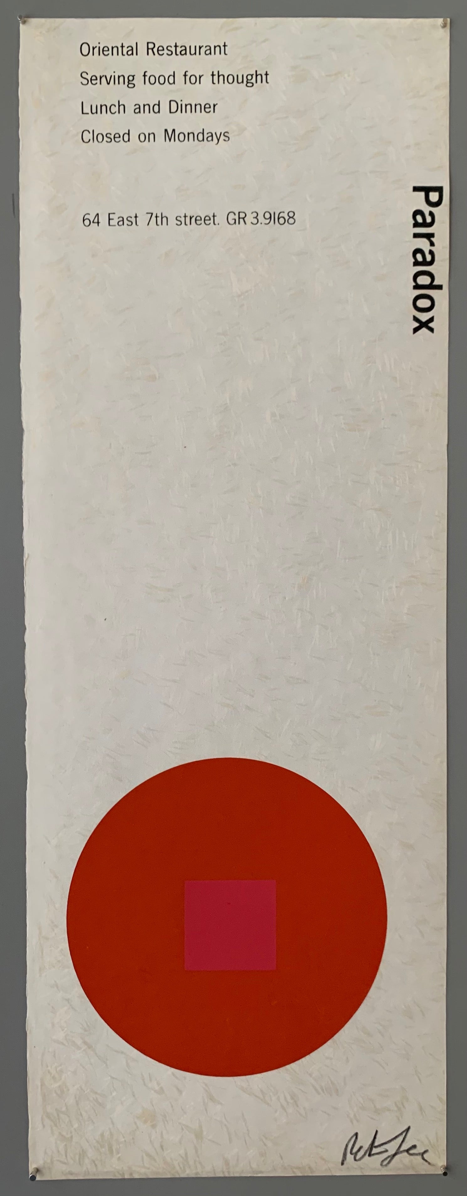 A red circle with an pink square on a white patterned paper.