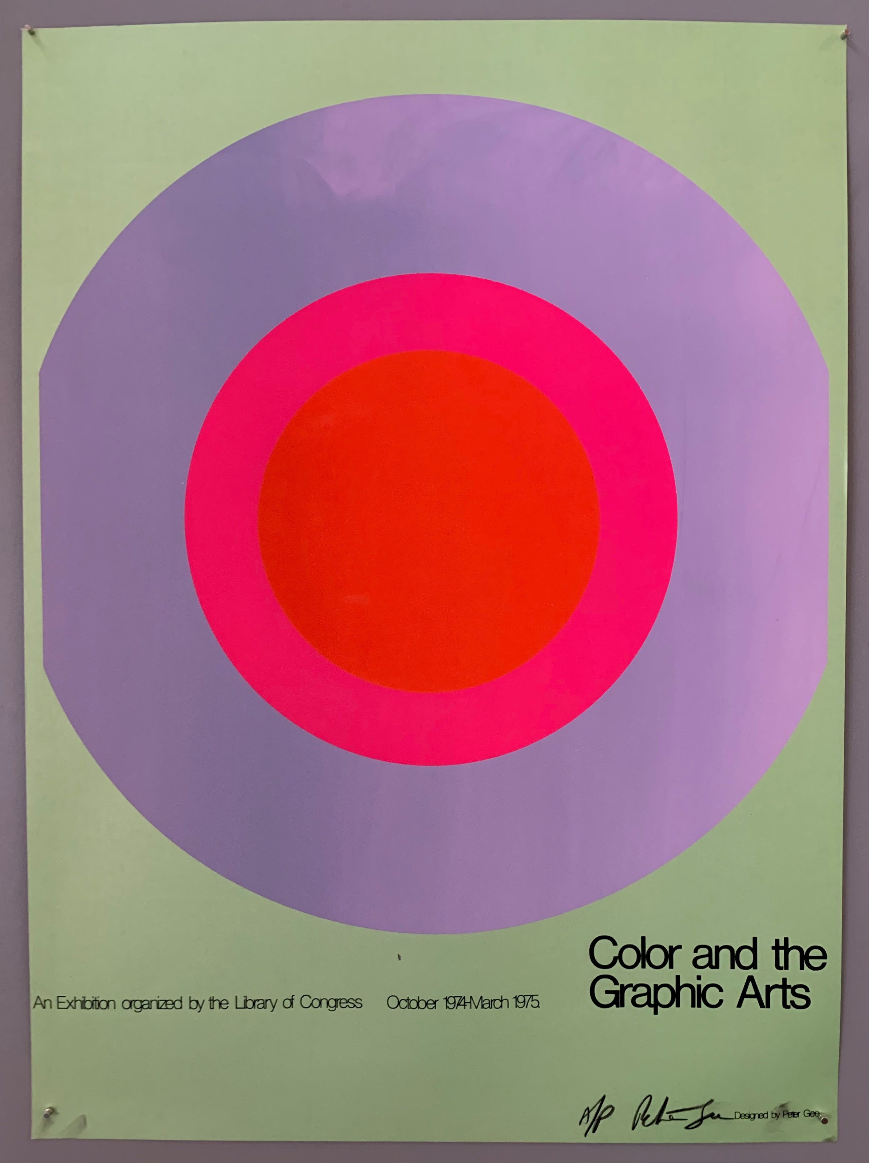 A large target takes up the center of the page, with the writing small beneath it. The colors are mint green, iris, hot pink, and bright red.