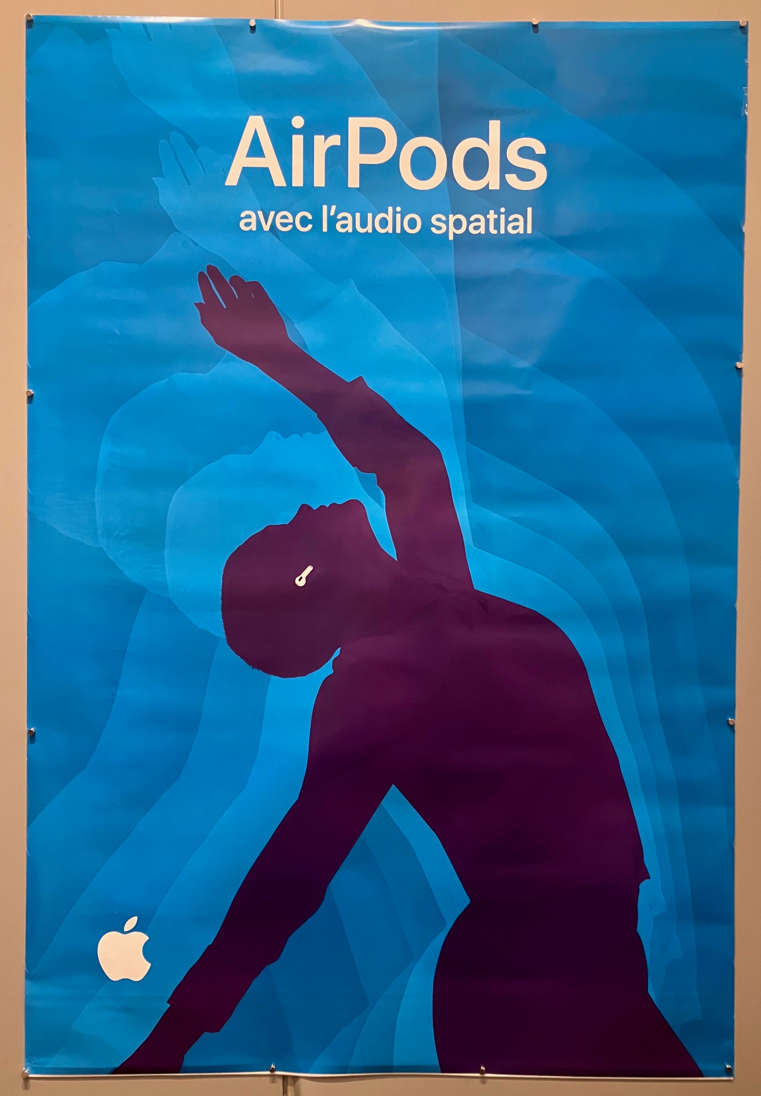 69x47 french apple advertisement for 3rd generation airpods with spatial audio featuring dark purple silhouette of person dancing with white airpods and light blue background