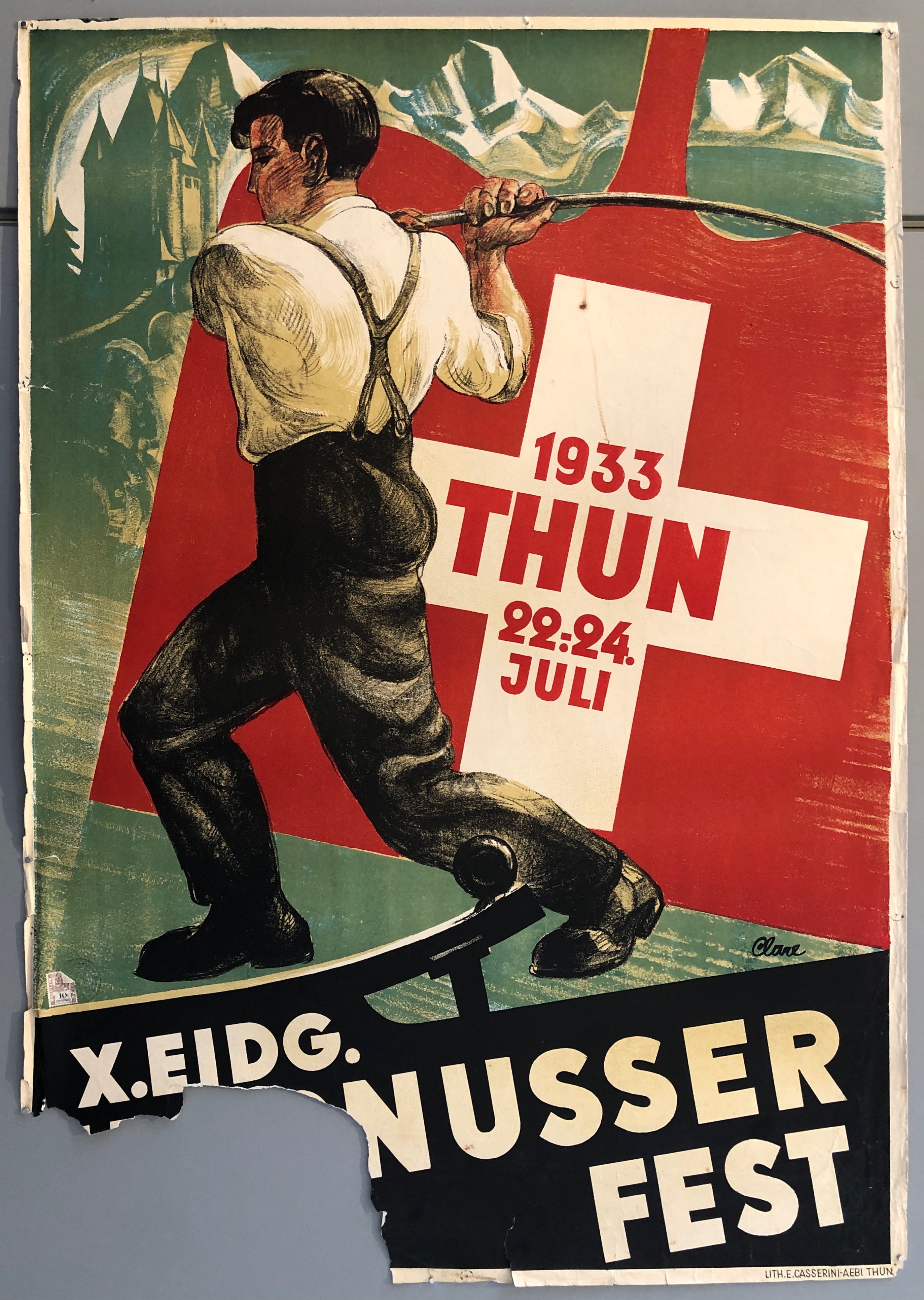 Poster showing a boy with a stick before an image of the Swiss flag
