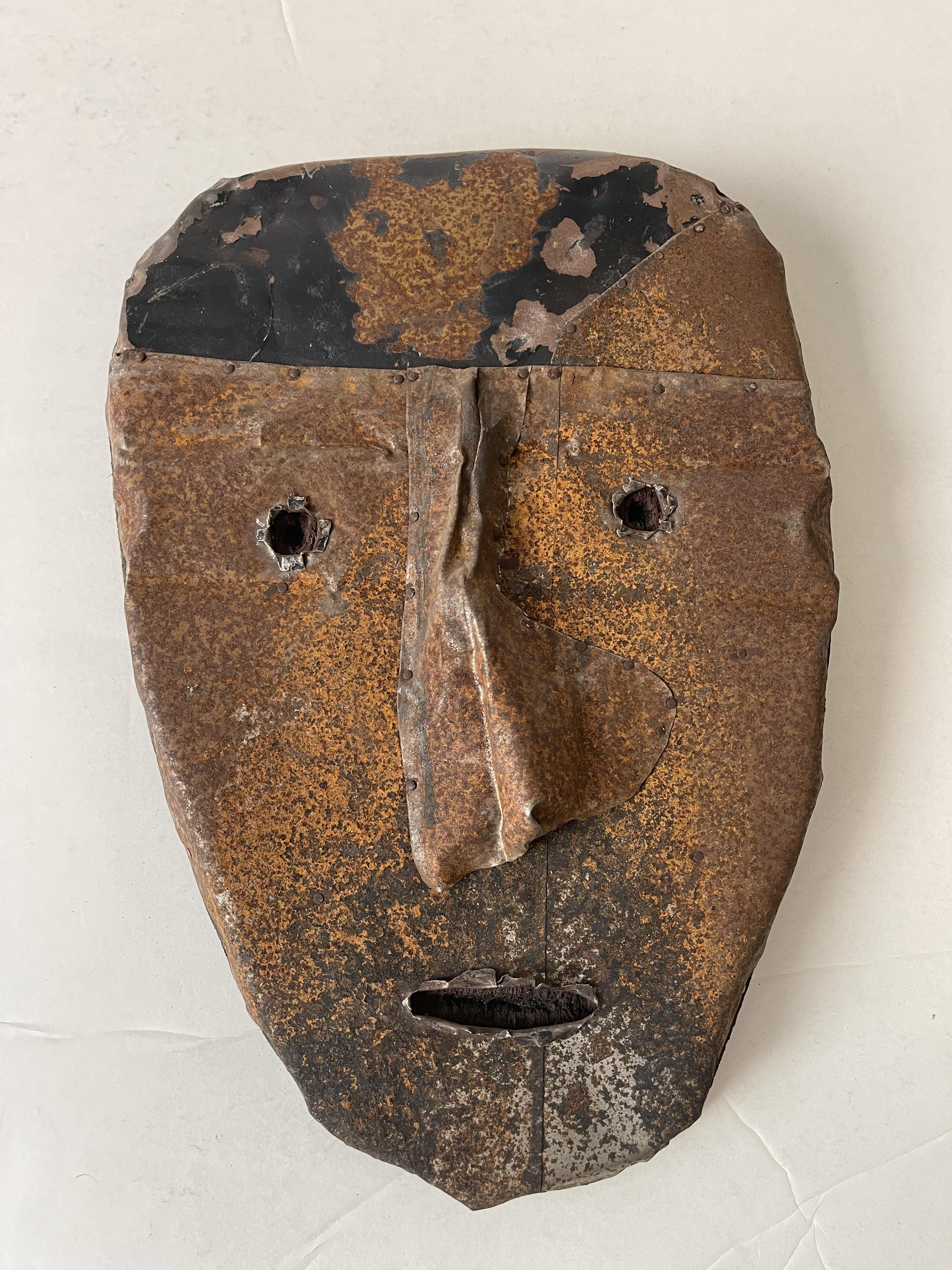 rusted roofing tile made into face. nose large
