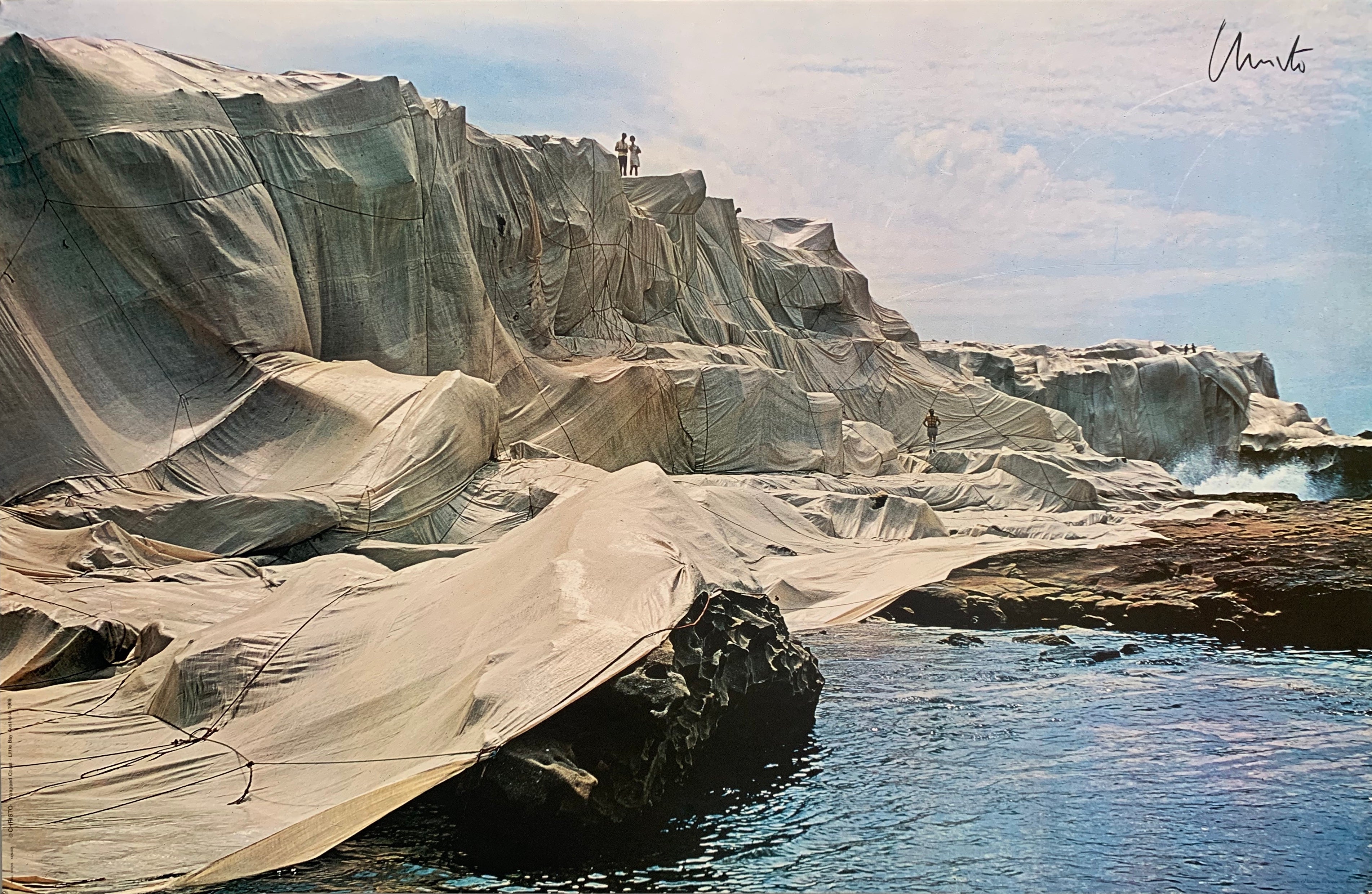 Colored photograph of rocks covered in white fabric.