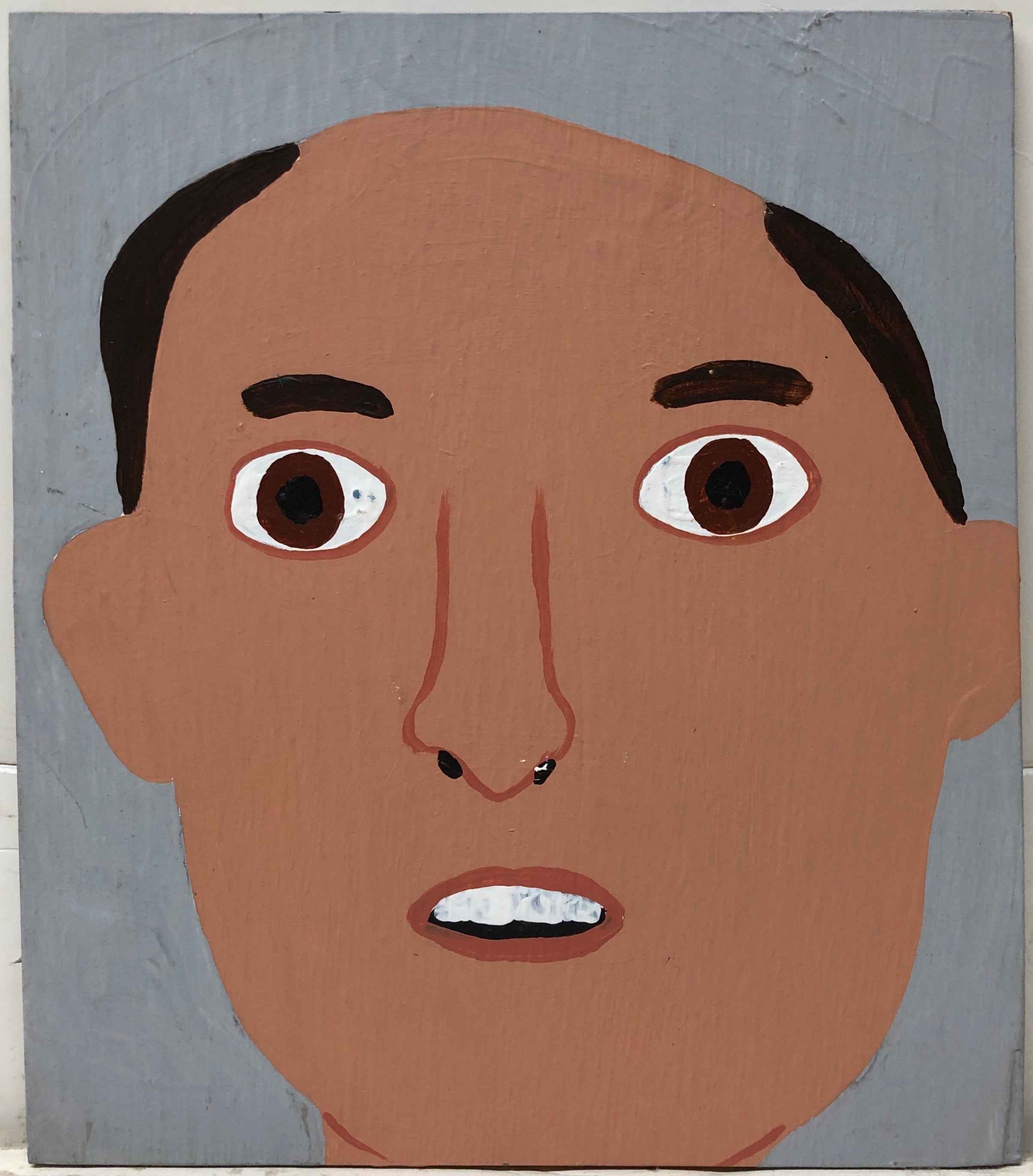 Portrait of Brian Bilcher, bald except for tufts of brown hair at this temples.